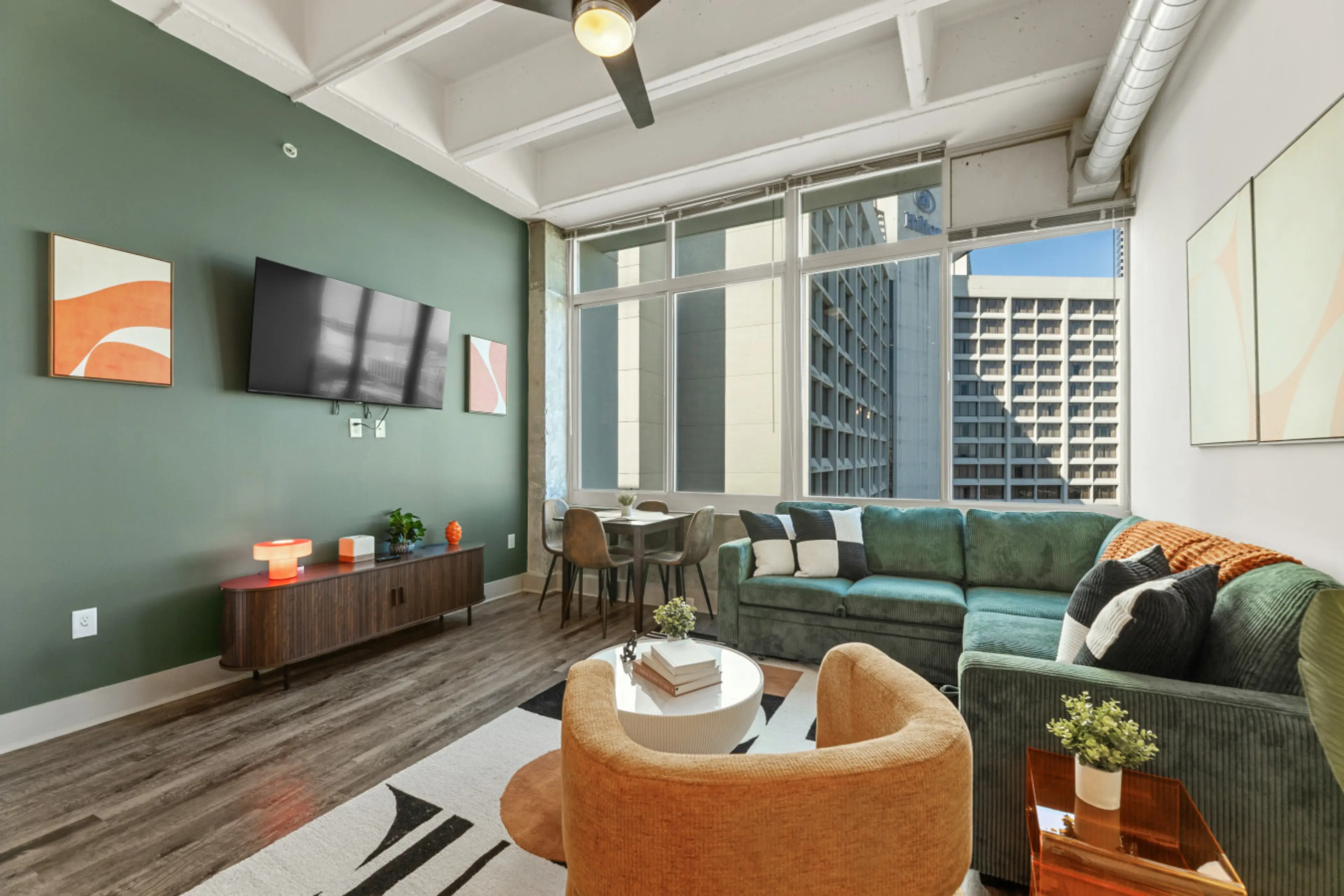 Stylish retreat with vibrant decor and city views, perfect for relaxation or gatherings!