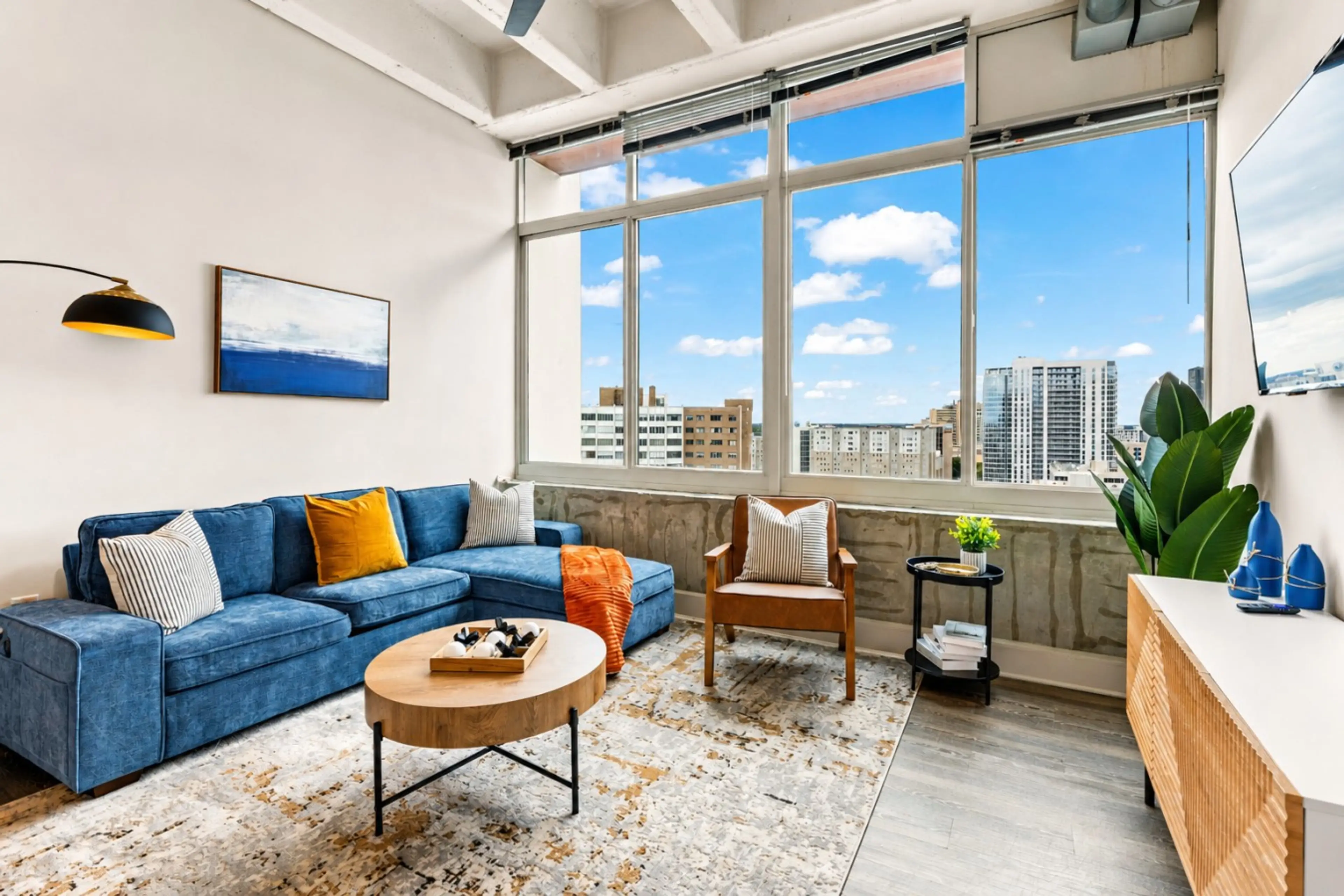 ChatGPT Image May 30, 2026, 11_18_53 Pelax in a stylish living room with floor-to-ceiling windows and city views.M