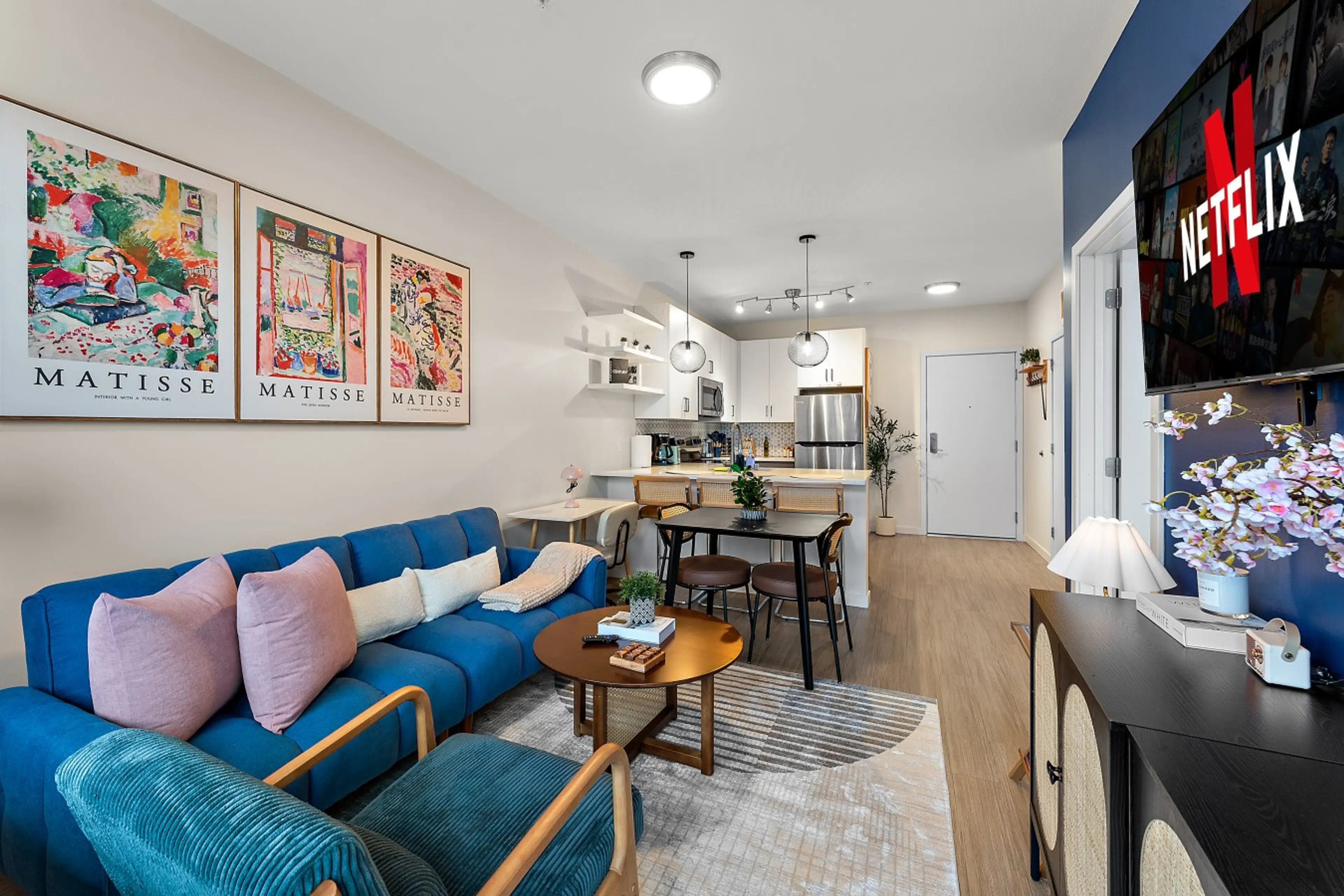 Open-concept living and dining area with modern decor, comfortable seating, and a welcoming city-stay vibe.