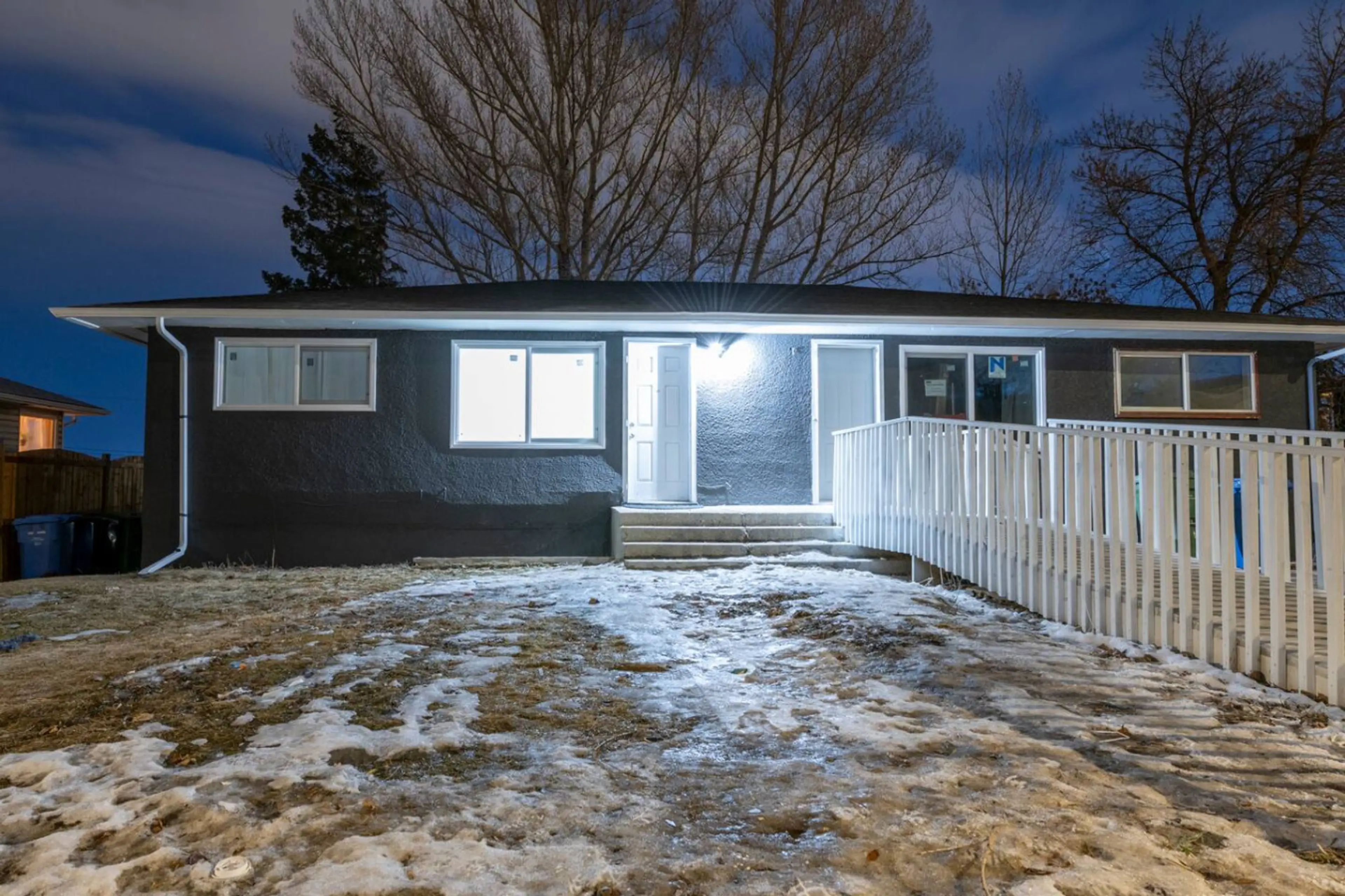 Private entrance illuminated at night for easy and secure access.