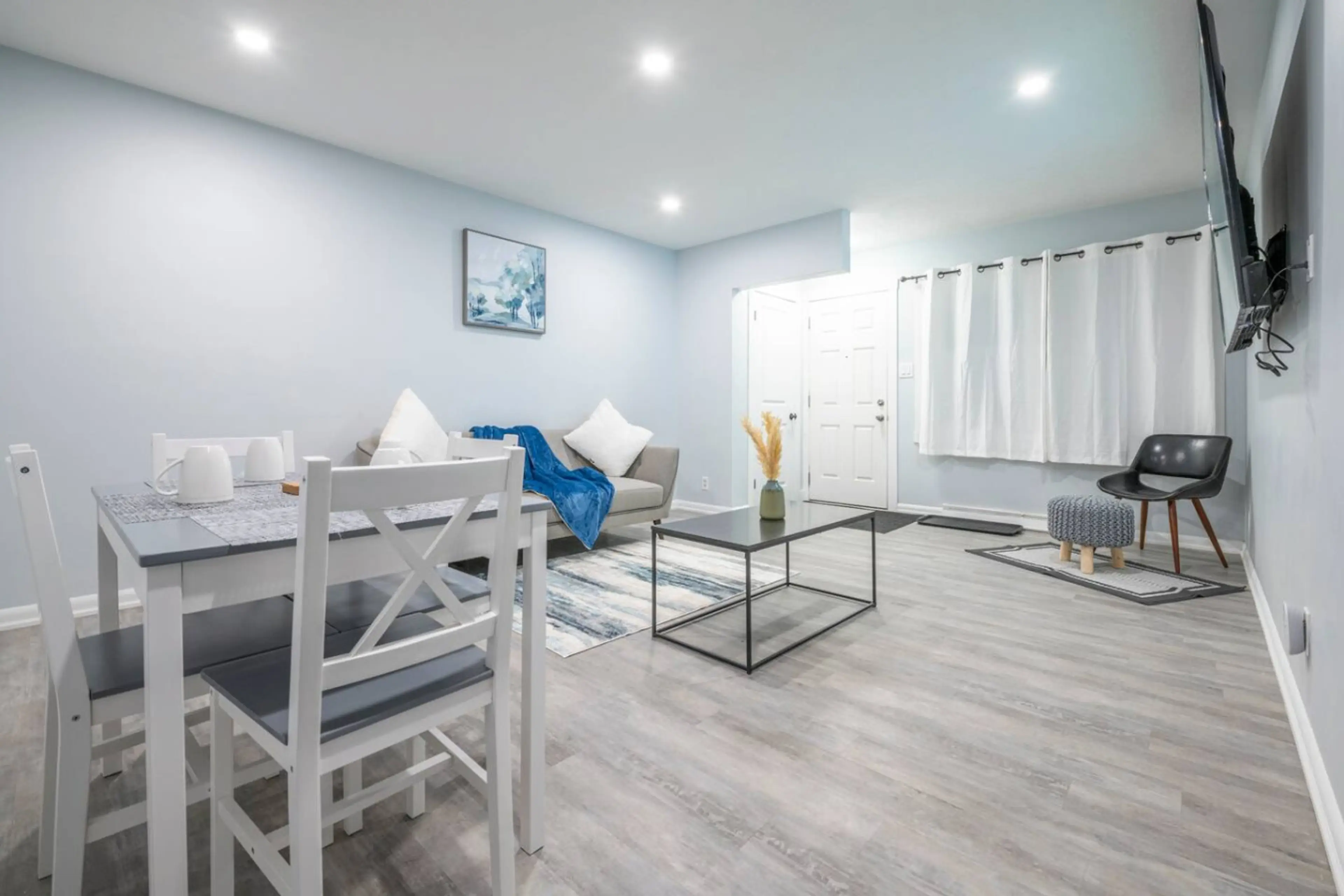 Bright open living and dining area with modern décor and cozy seating.