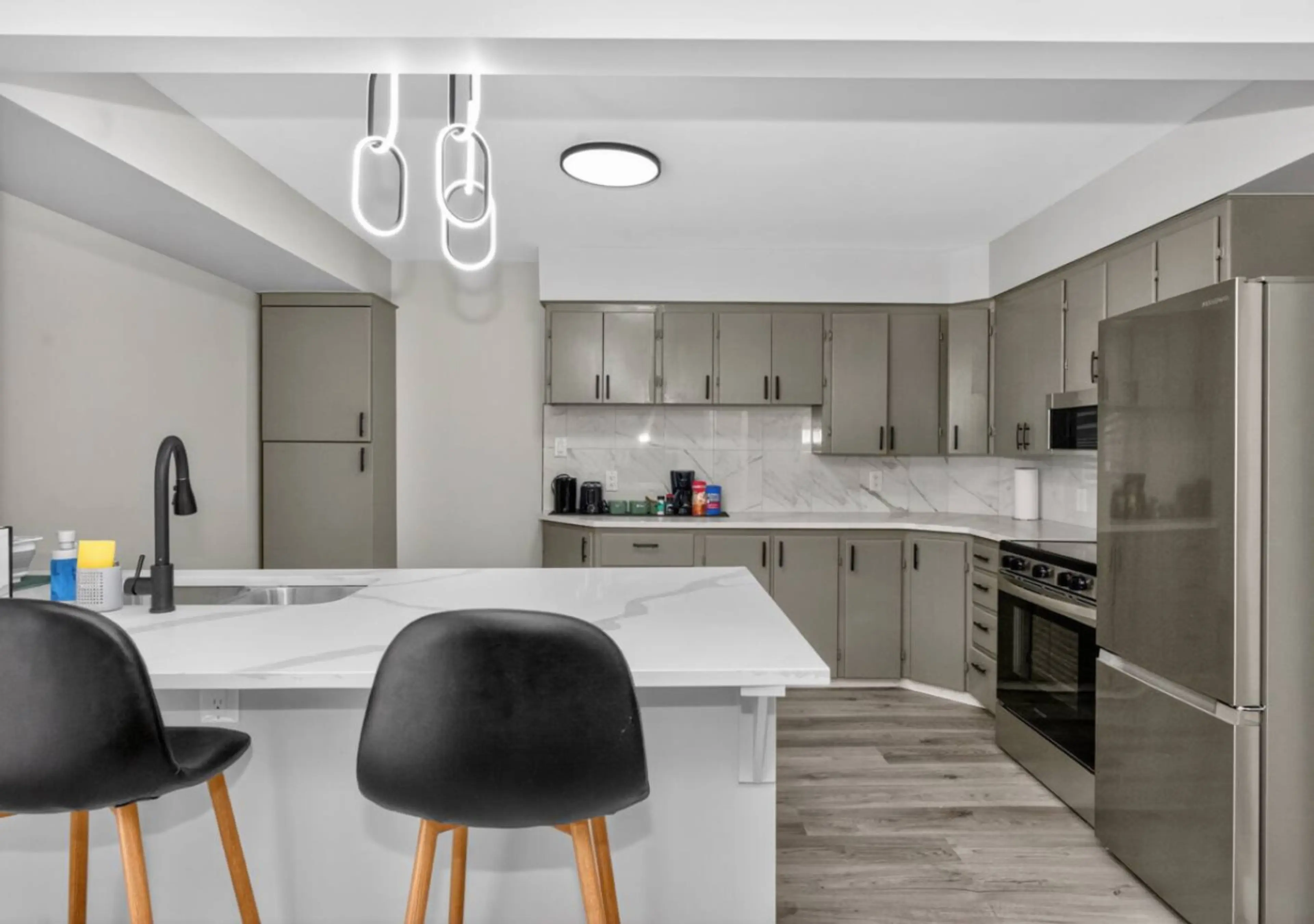 Bright modern kitchen with quartz island, stainless steel appliances, and plenty of space to cook and gather.