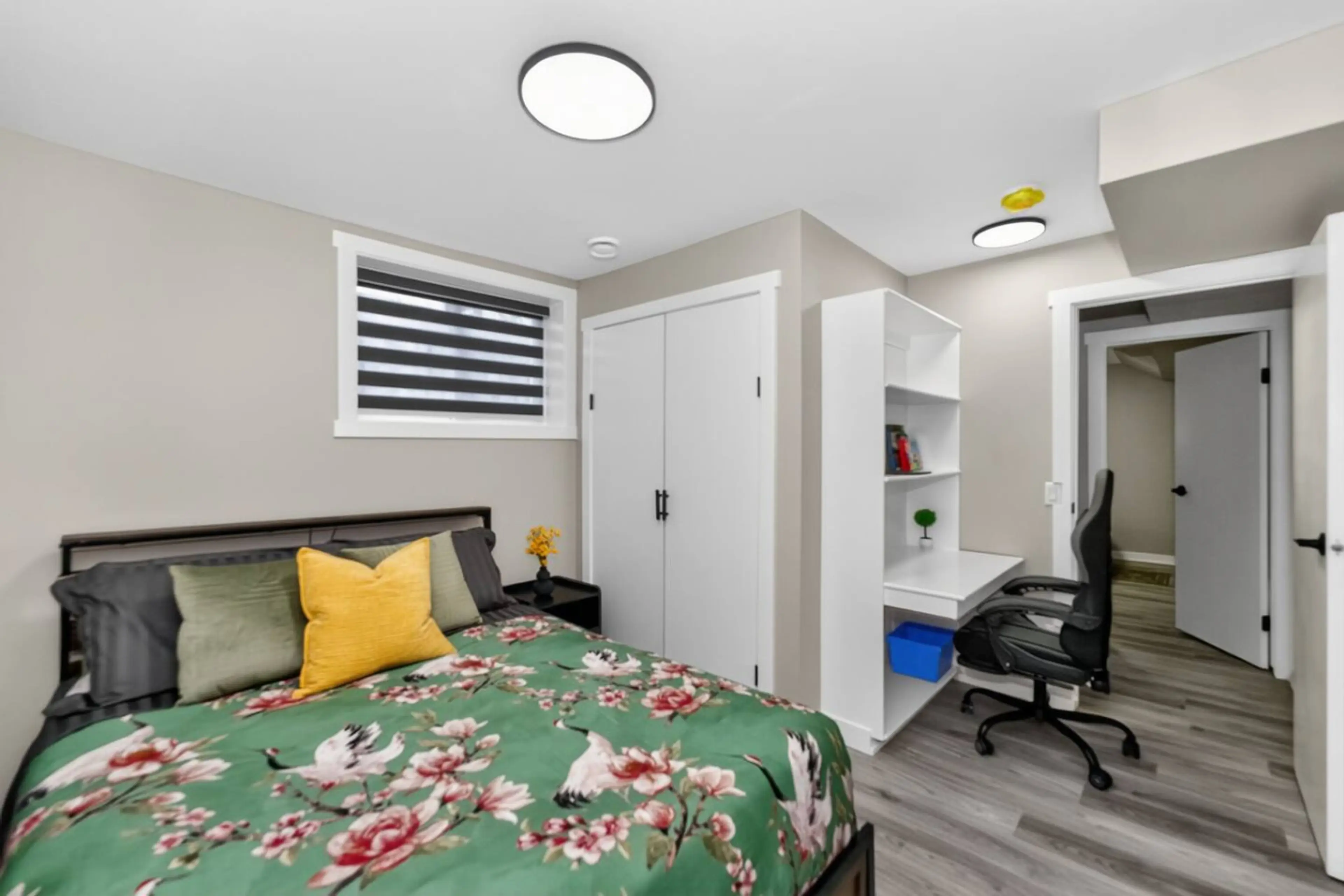 Comfortable bedroom with dedicated workspace and natural light