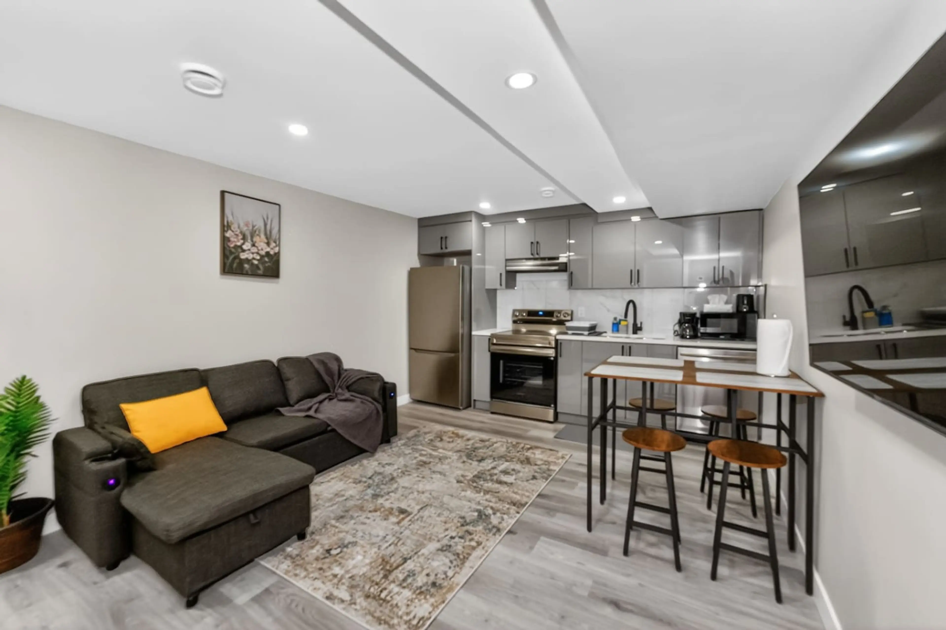 Spacious open-concept living area with full kitchen and modern design