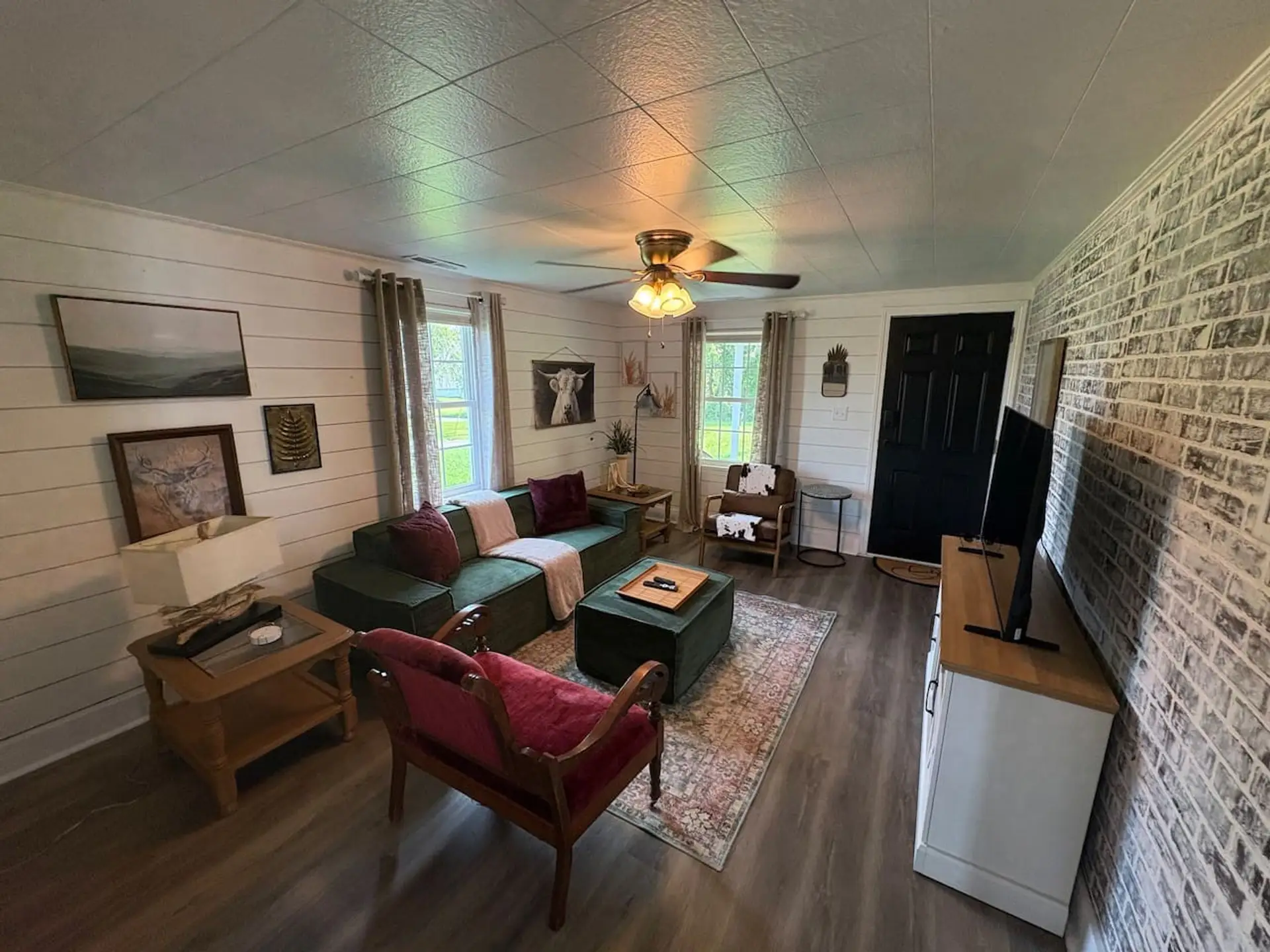 Cozy living room with a sofa, armchairs and a Smart TV