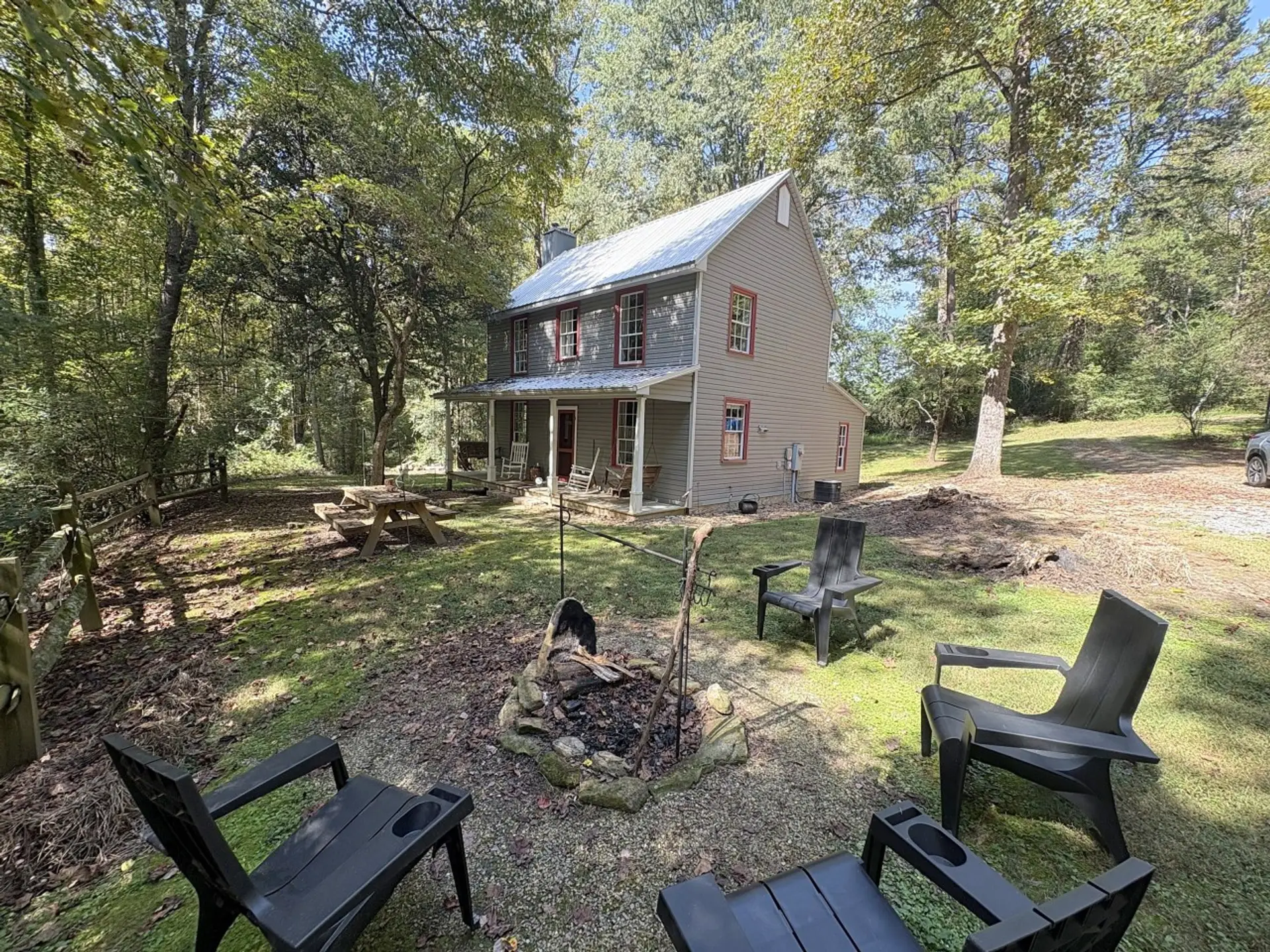 Farmhouse with firepit and Adirondack chairs