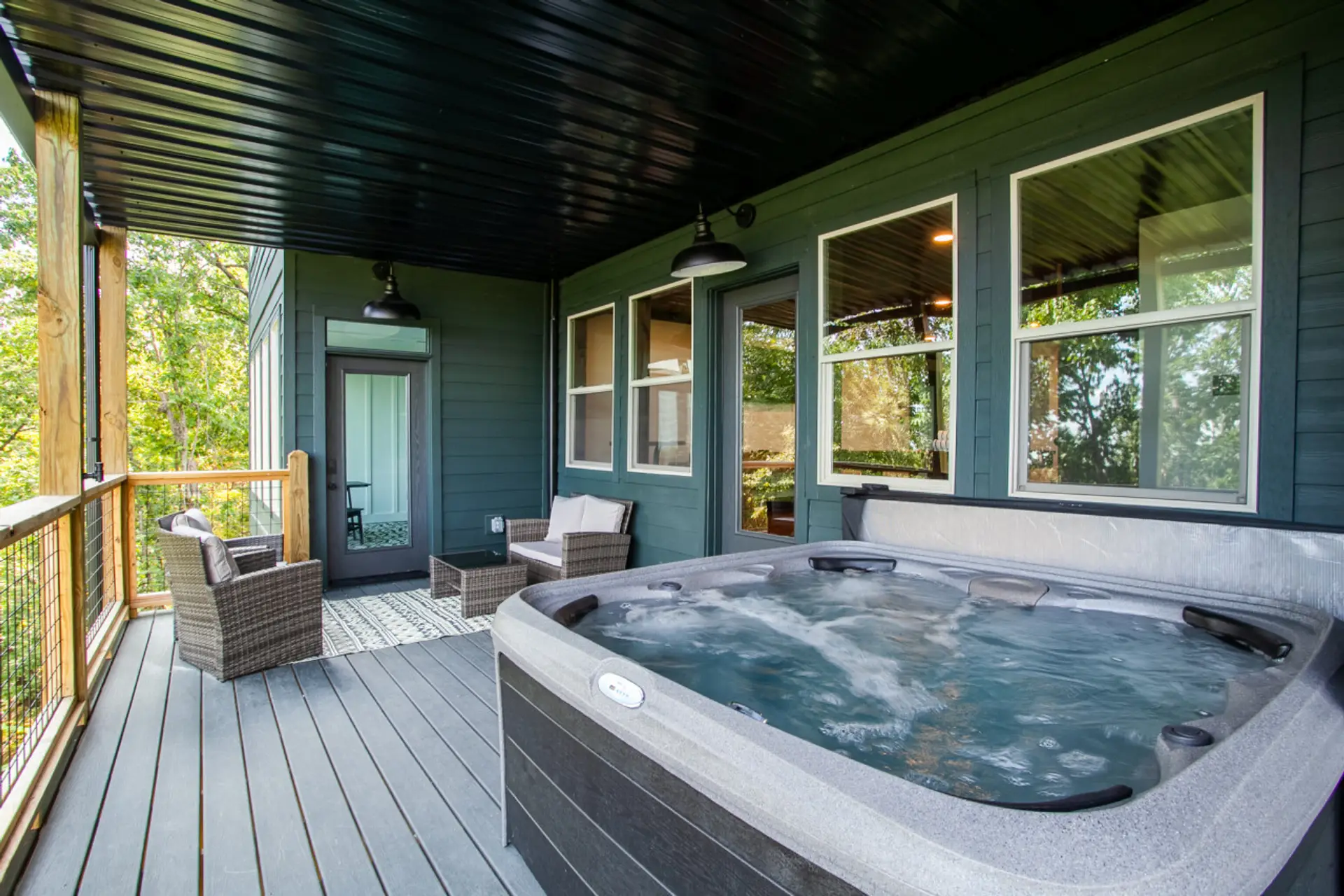 Step into relaxation! Picture this: a hot tub bubbling with warmth and chairs perfectly placed for optimal chill time.