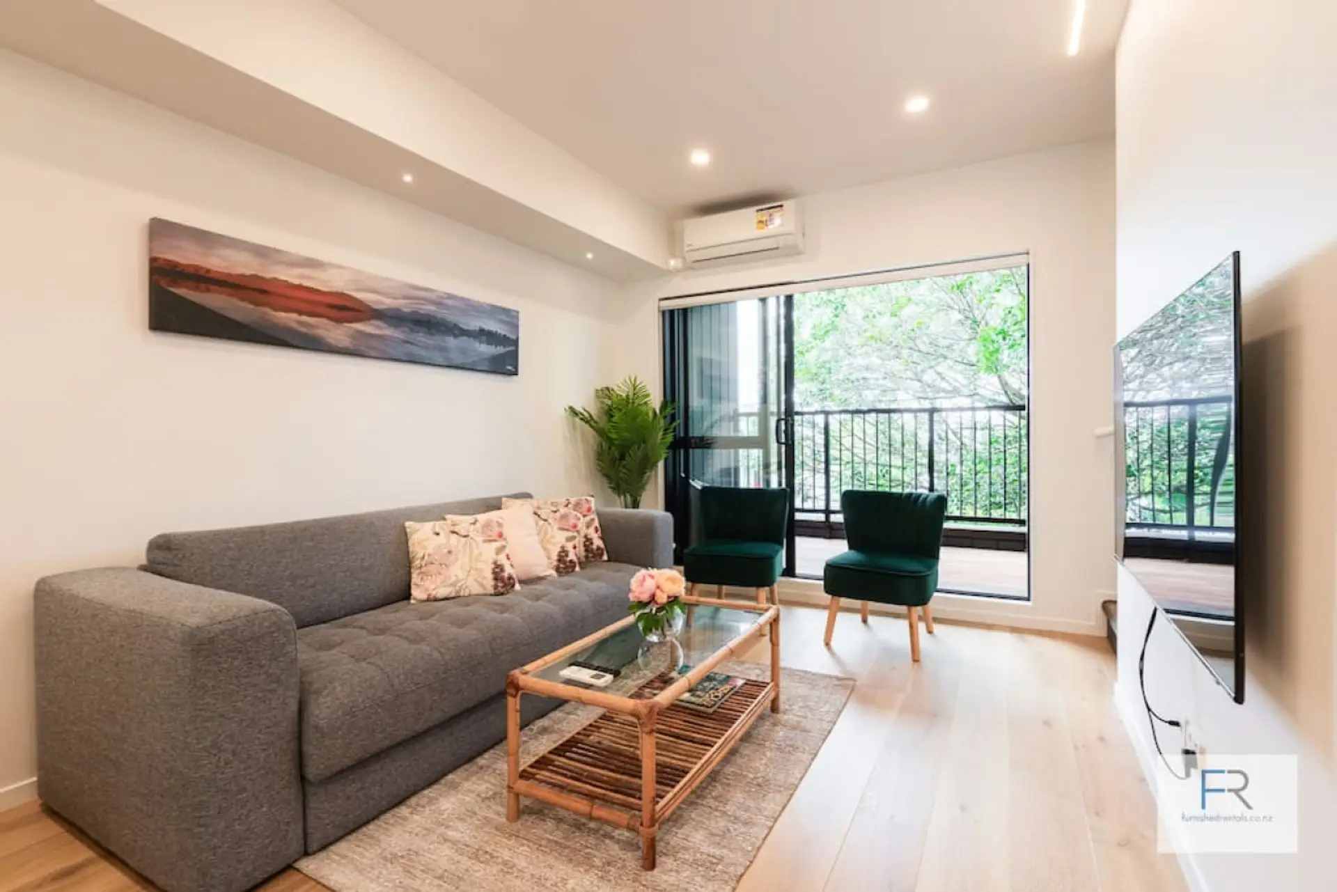 Lovely open plan lounge with heat pump/air con and doors opening to private deck.