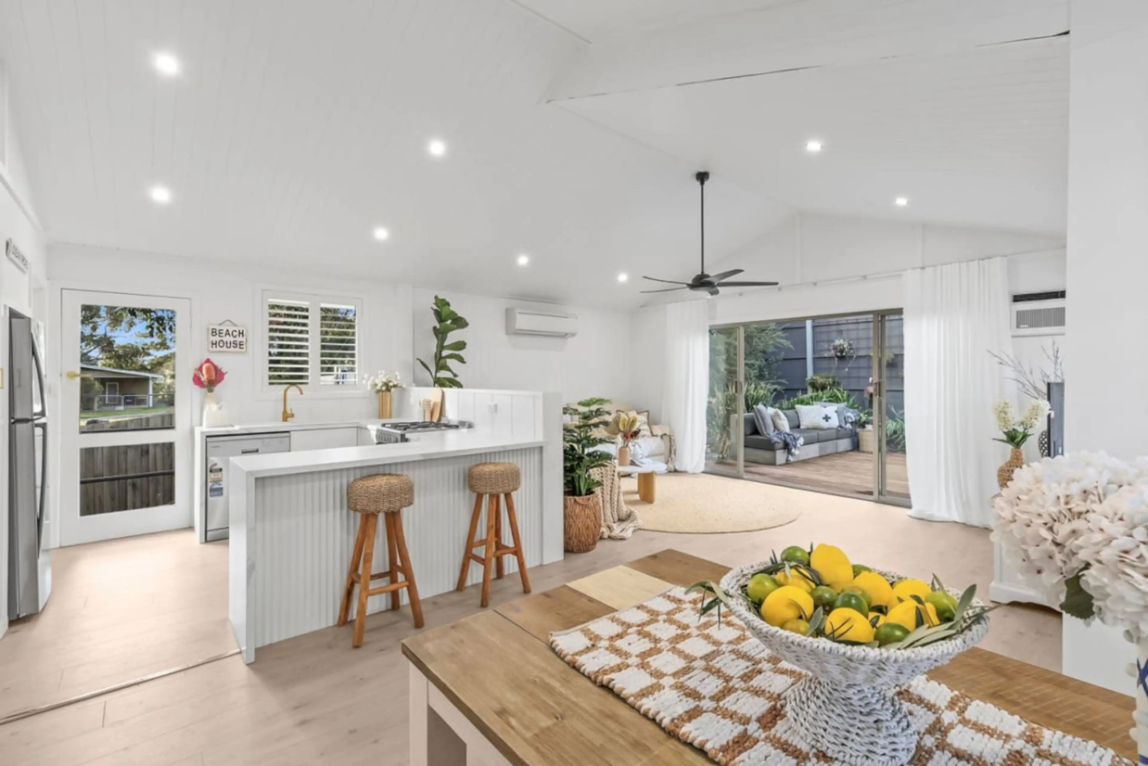 Open-plan kitchen and living flowing out to the private deck.