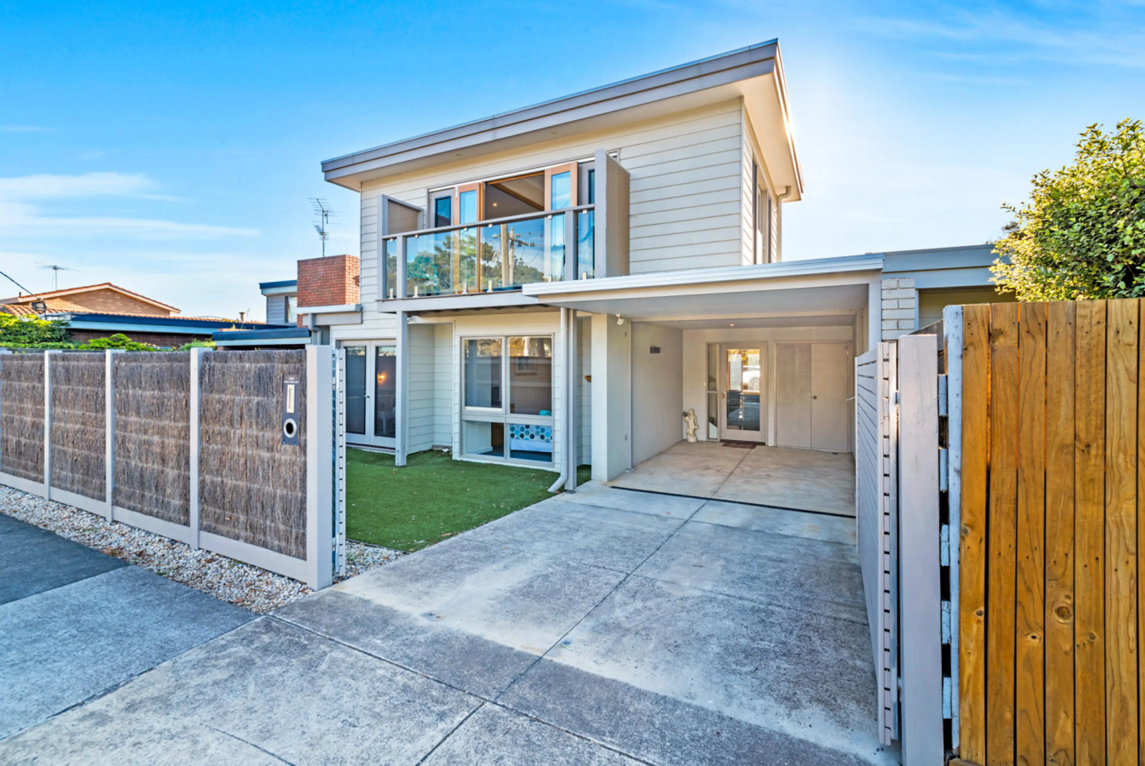 Modern two-storey home with secure gated entry and private parking.