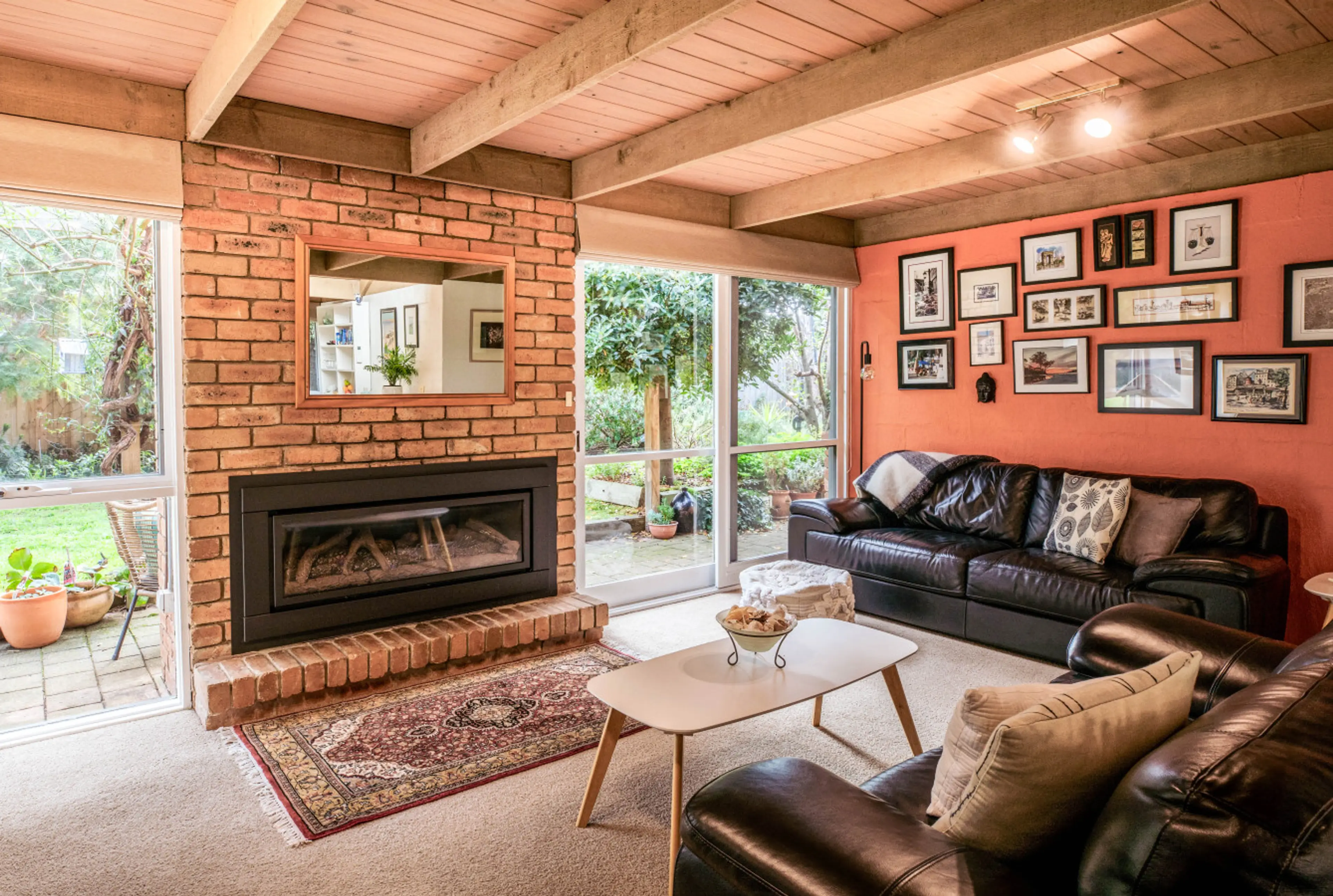 Cozy brick fireplace beside garden views, warmth and charm in every corner