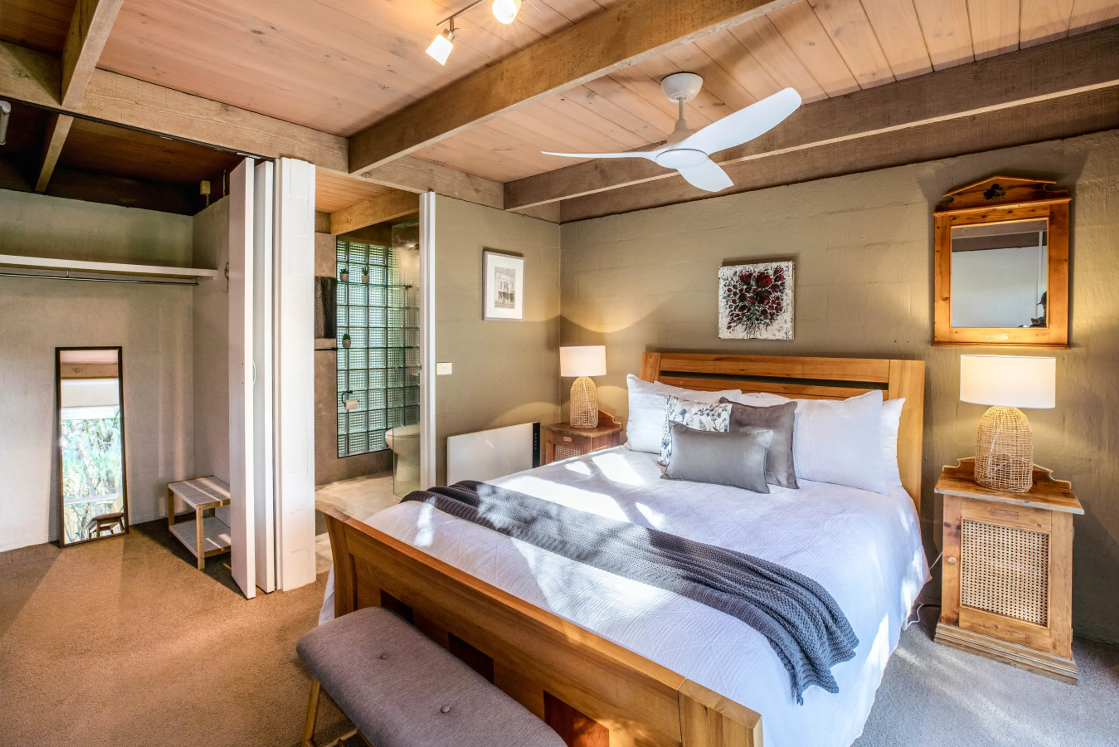 Sunlit timber bedroom wrapped in warm textures, pure comfort in every moment