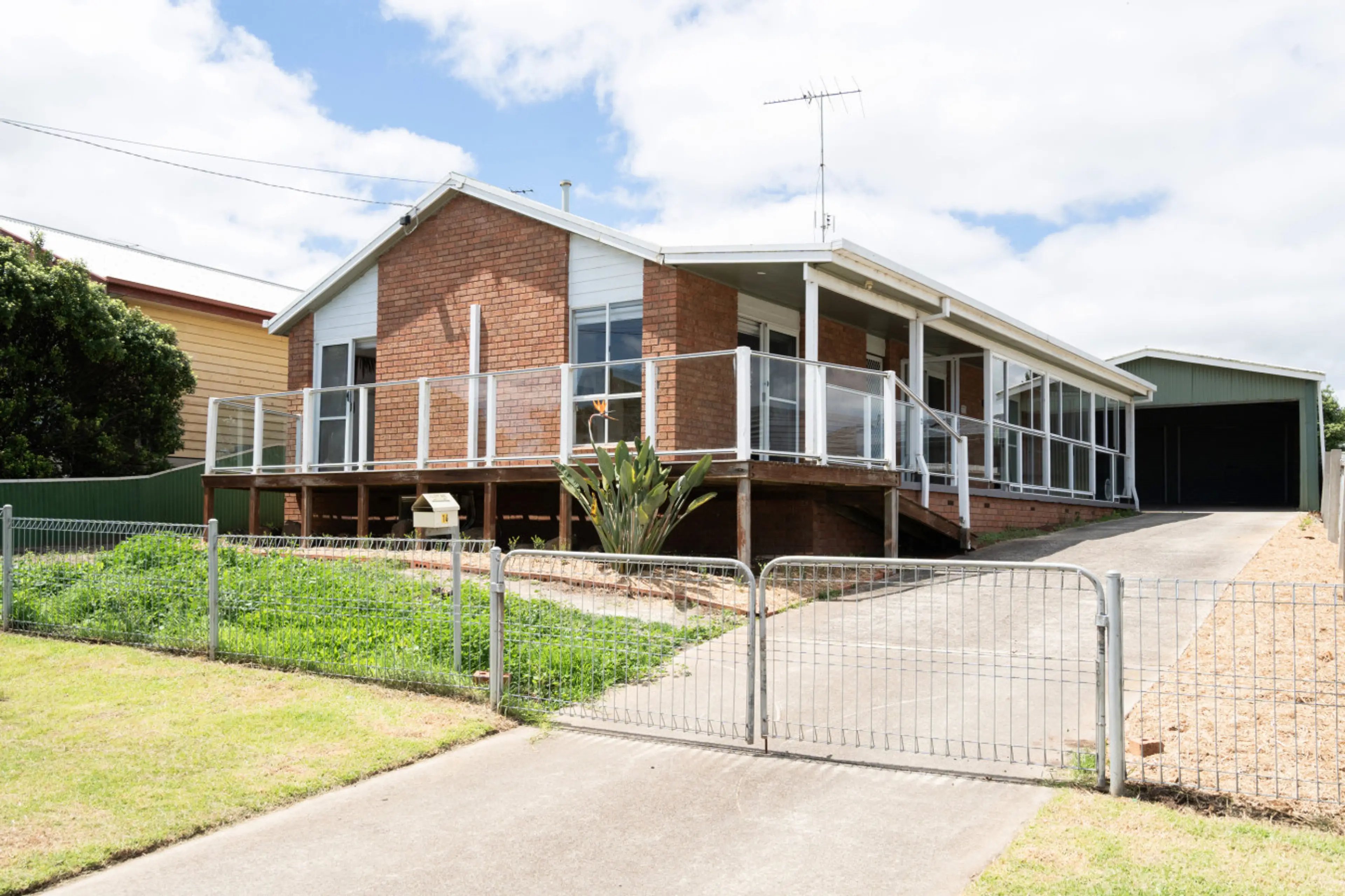Charming property exterior with elevated deck and welcoming entrance.