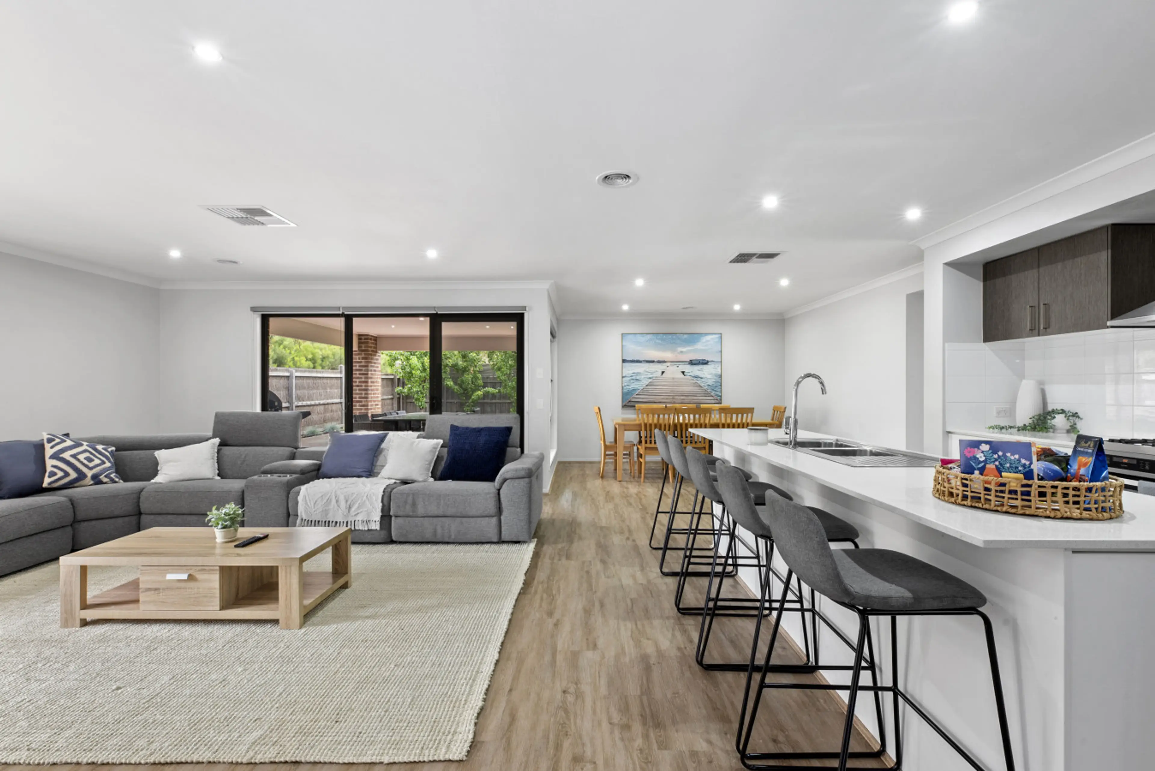 Spacious open-plan layout with modern kitchen, dining, and comfortable living area.