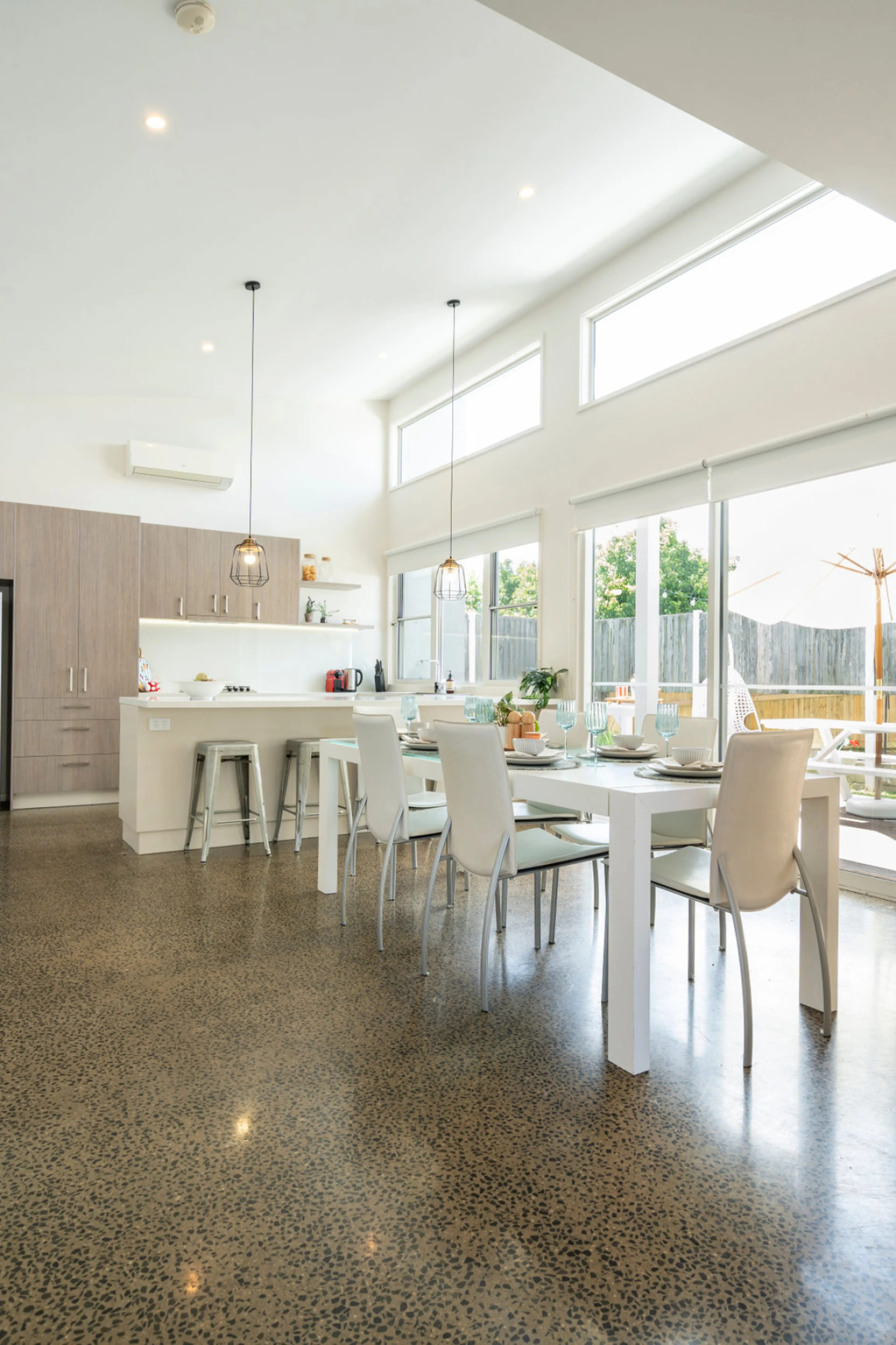 Bright dining and kitchen space with soaring high ceilings.