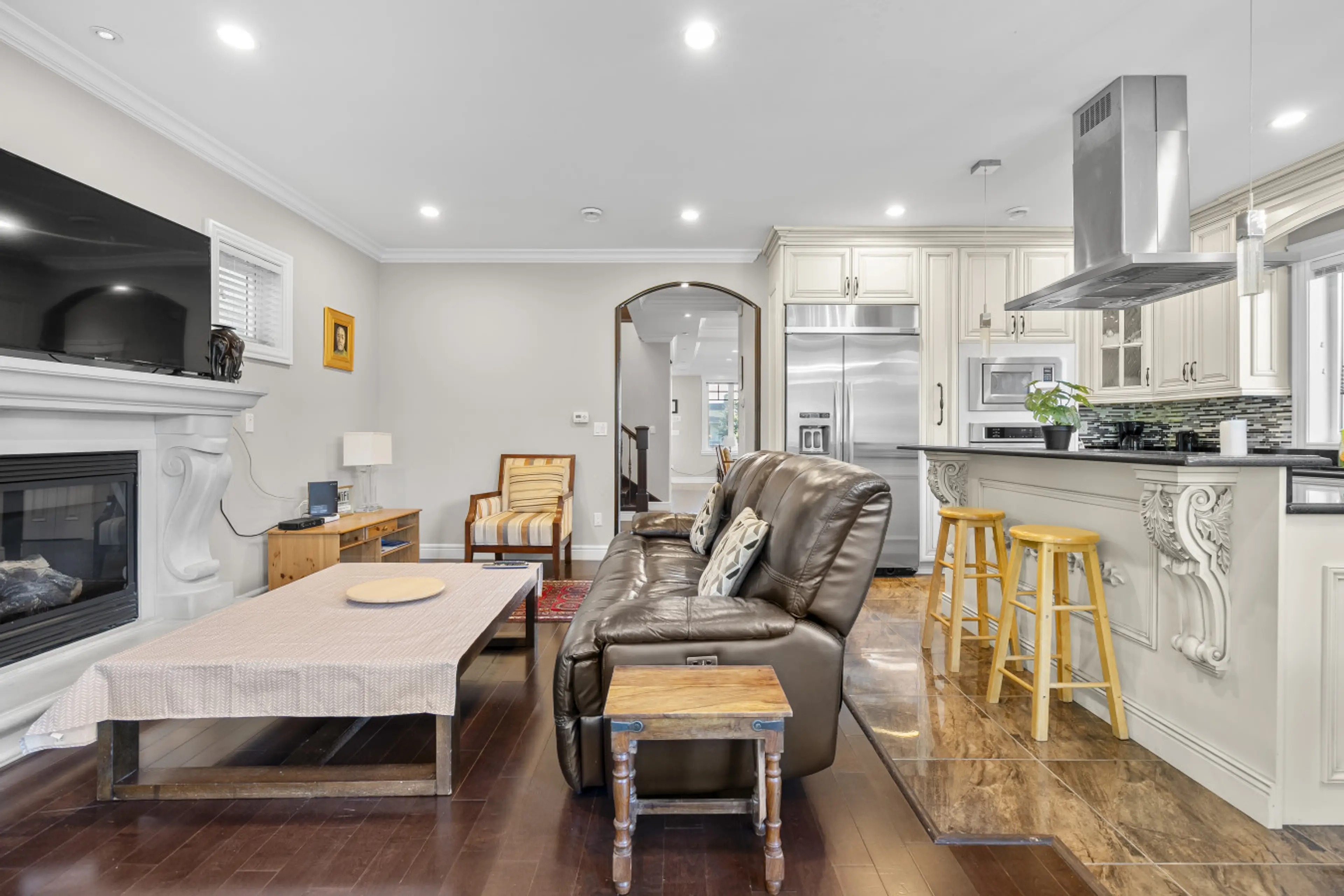 Warm open-concept living space flowing seamlessly into the gourmet kitchen