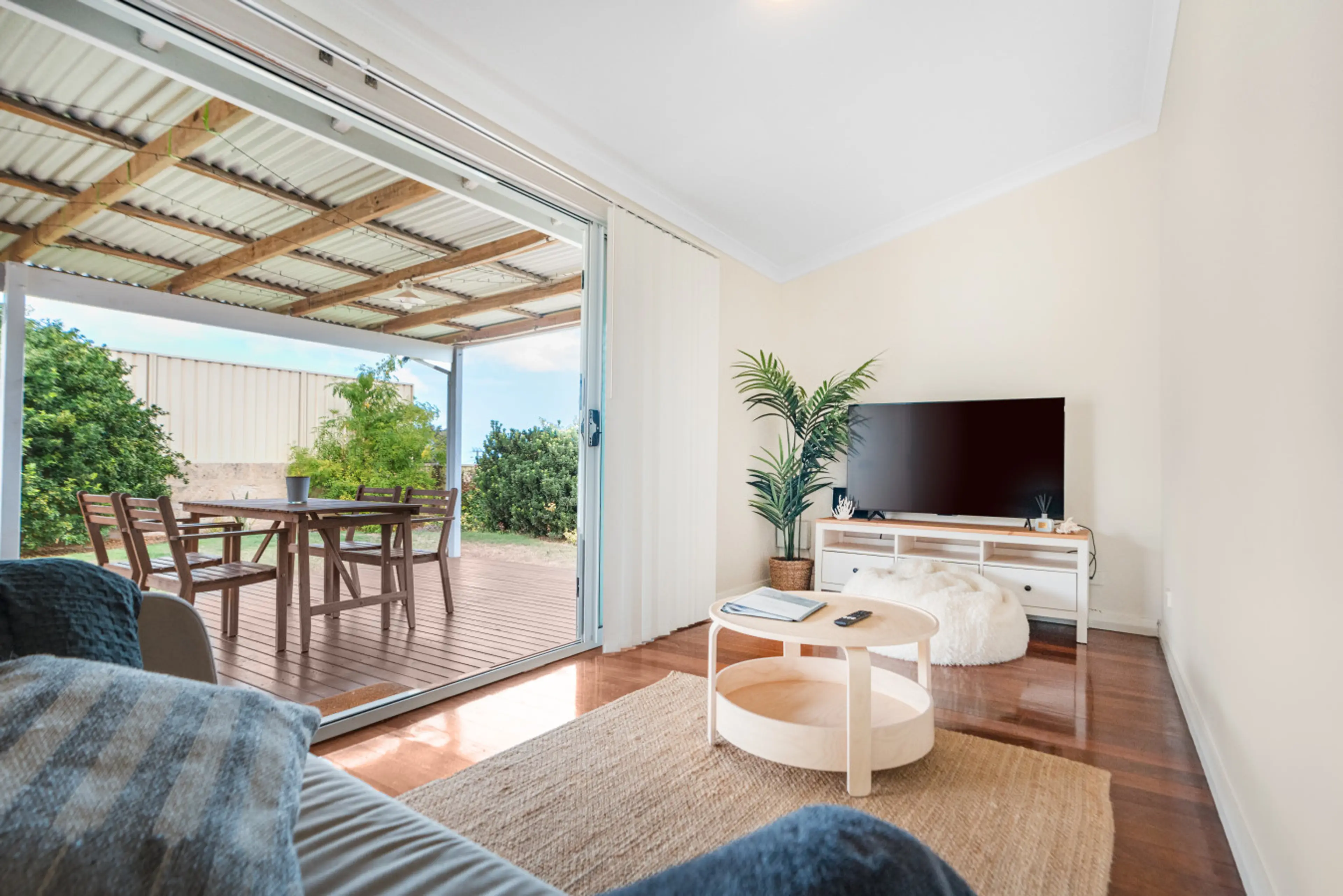 Relaxed TV lounge area with seamless access to outdoor dining and fresh air
