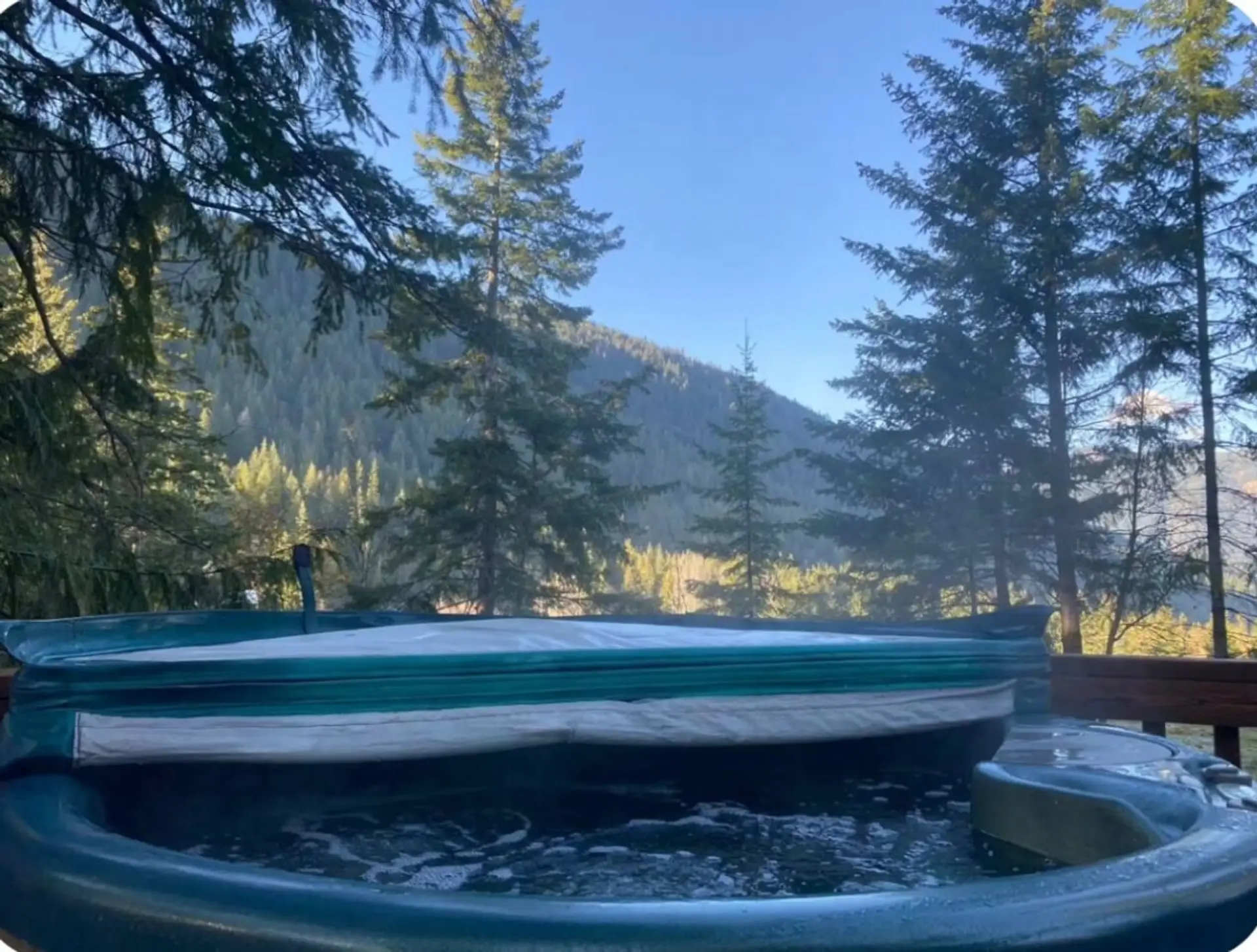Relax in the private hot tub with beautiful mountain views.