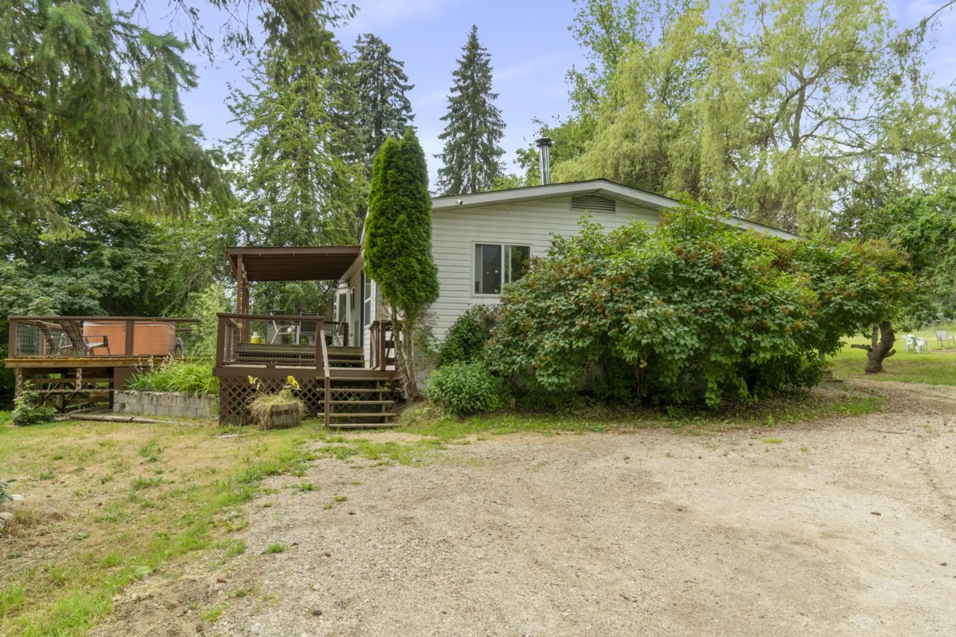 Private cabin with a spacious yard, deck, and hot tub.