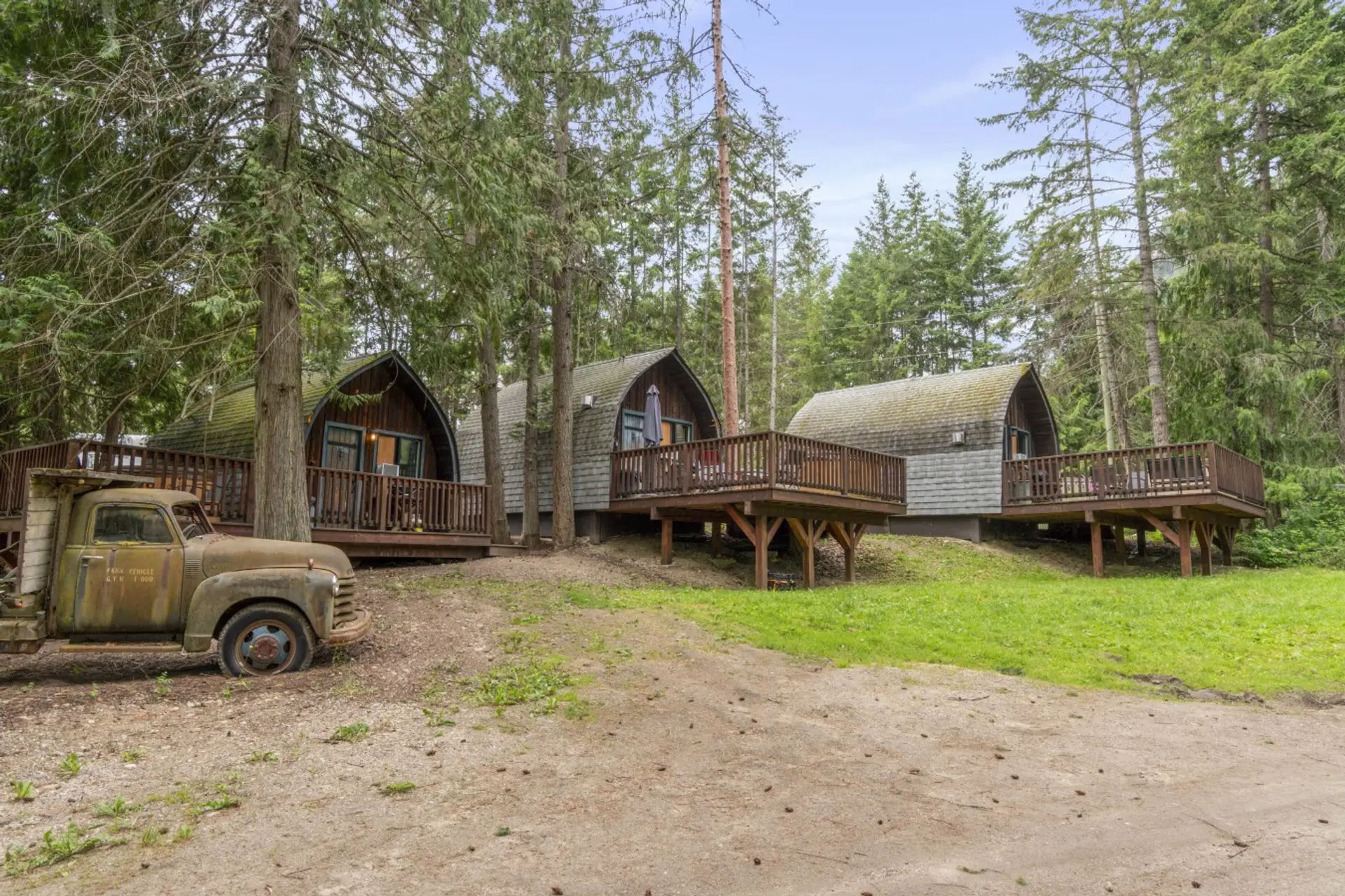 Cozy cabins nestled among the trees in a peaceful setting.