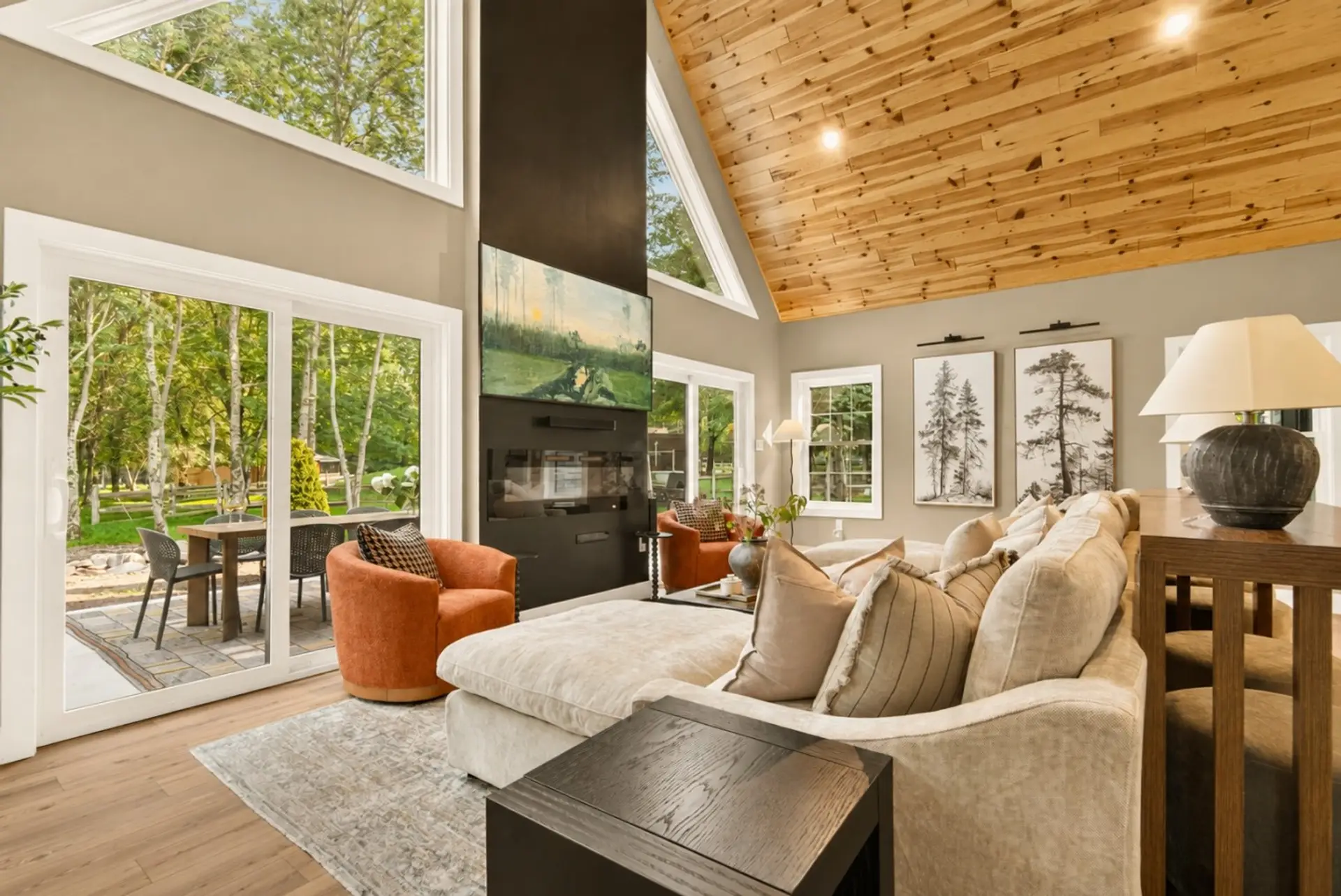 Sunlight, forest views, and soaring ceilings set the tone for slow mornings and cozy evenings together.