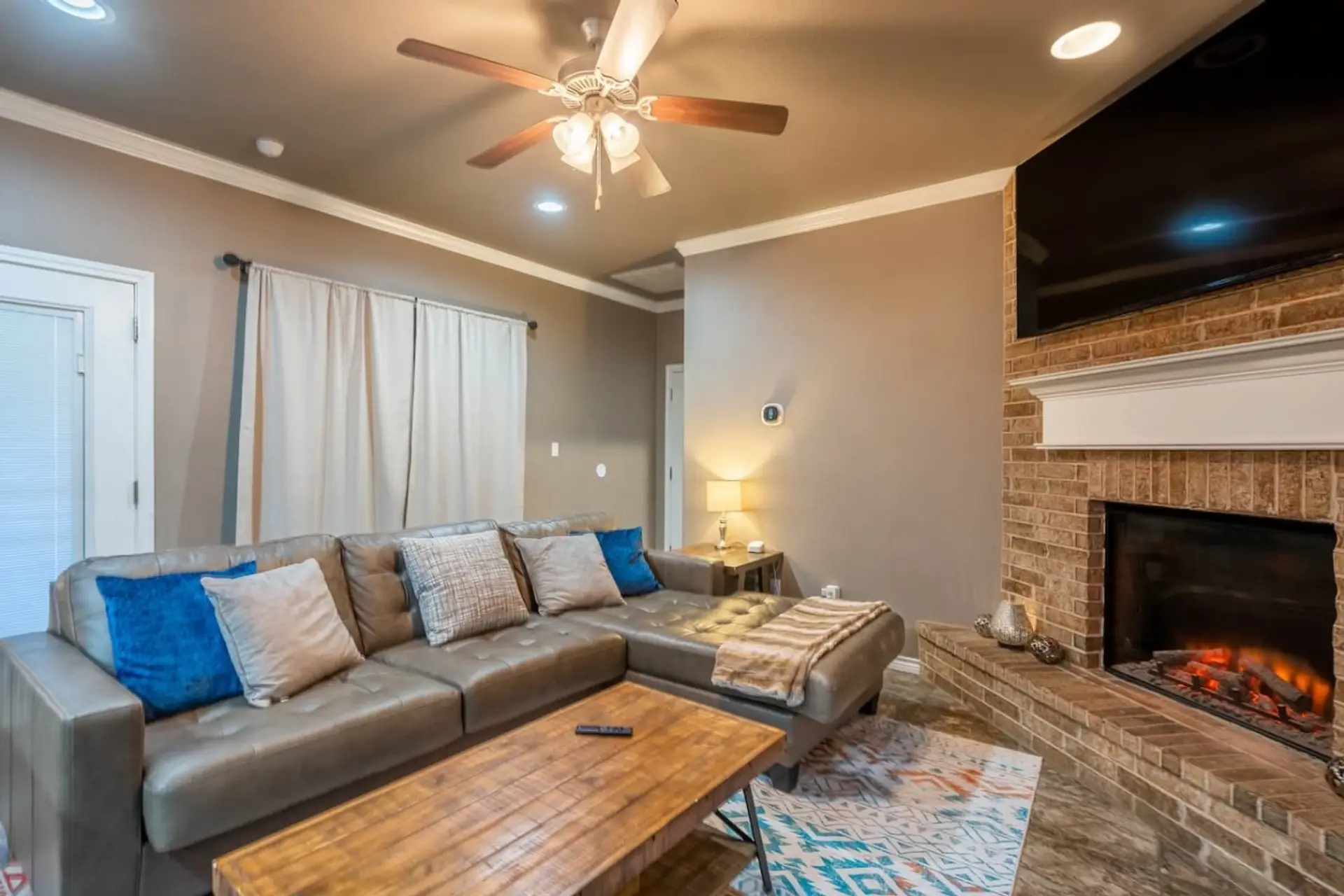 Kick back in the open, comfortable living room with a cozy electric fireplace and plenty of space to relax with your crew.