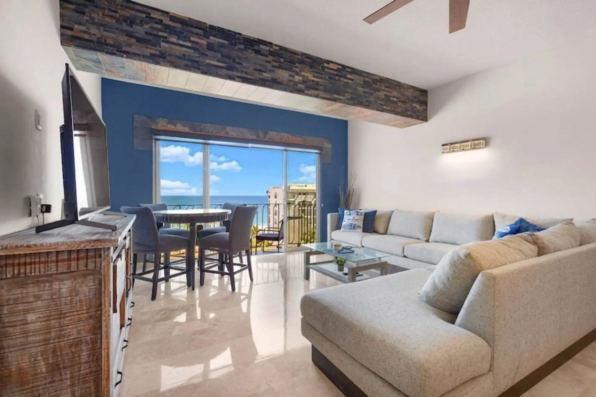 Bright living room with comfortable sectional seating and beautiful ocean views.