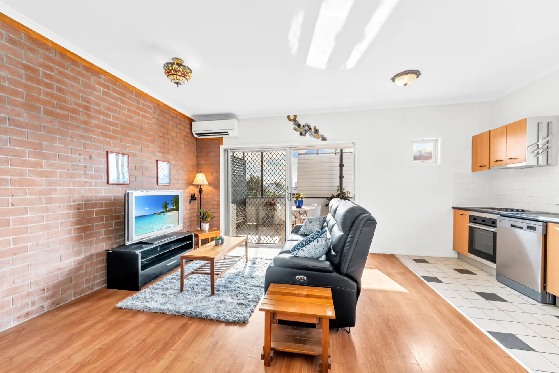 Open plan living, with split system AC and skyline views.