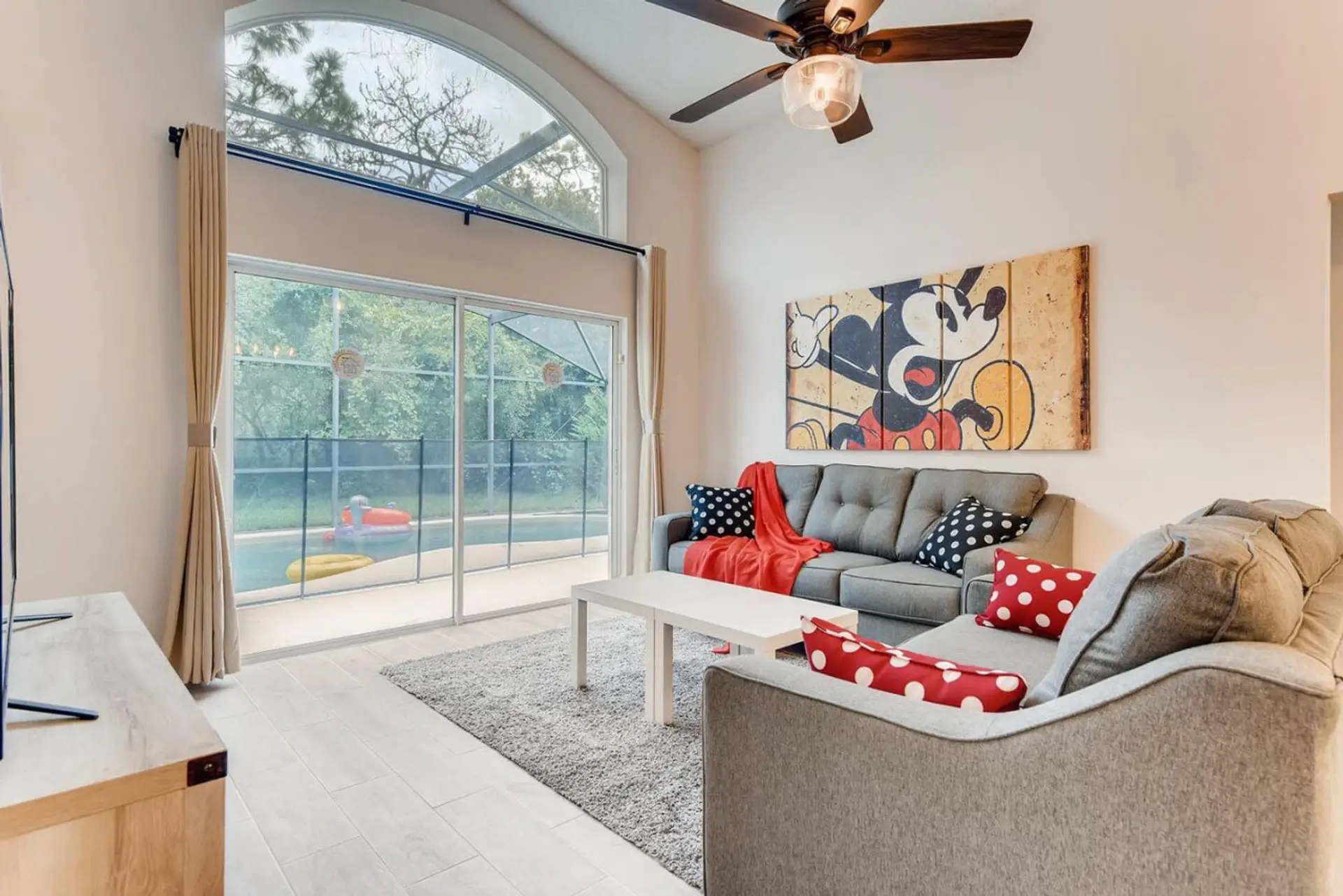 Bright and spacious living room with stunning pool views