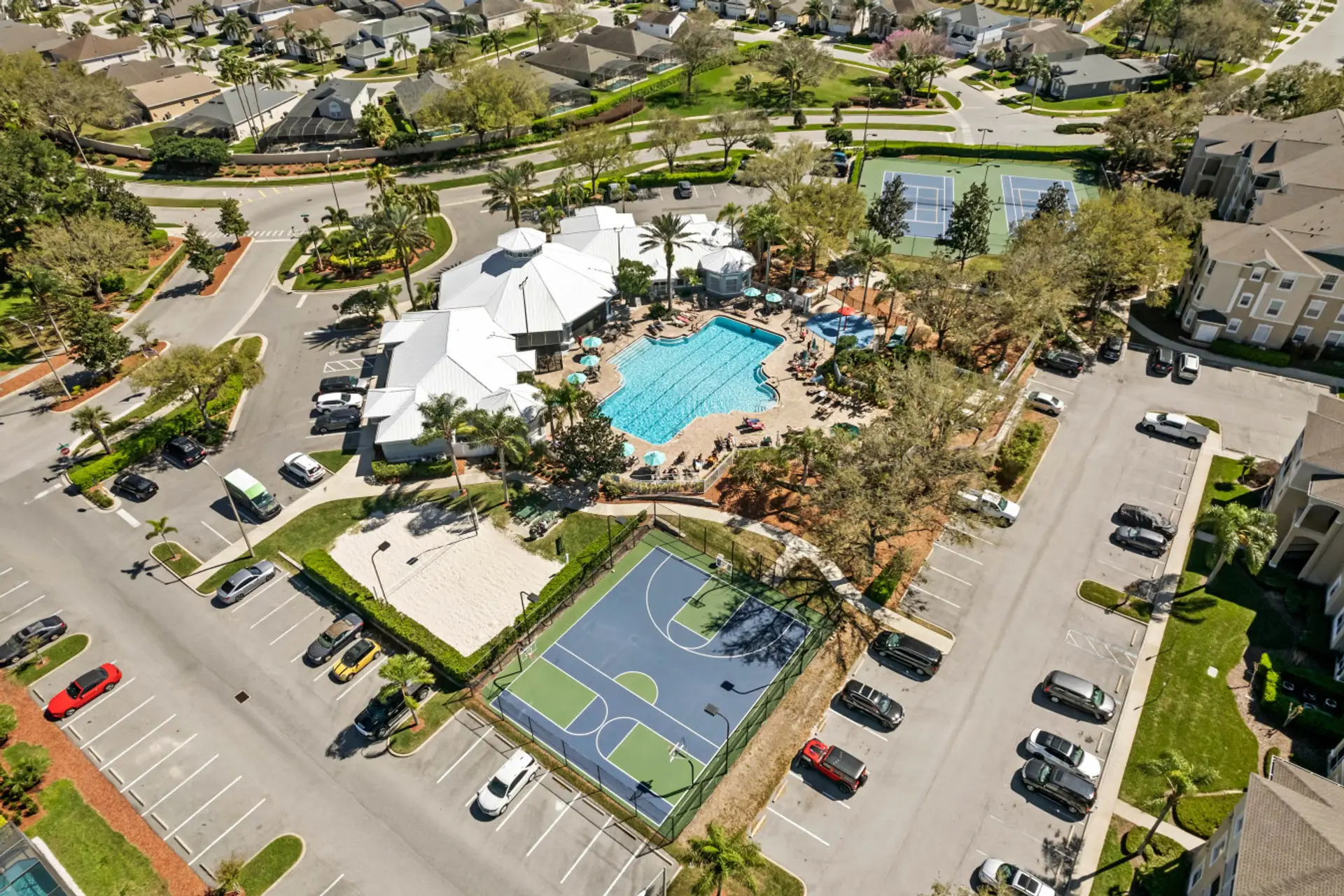 Aerial view of the resort featuring the pool, tennis courts, and beautifully landscaped grounds