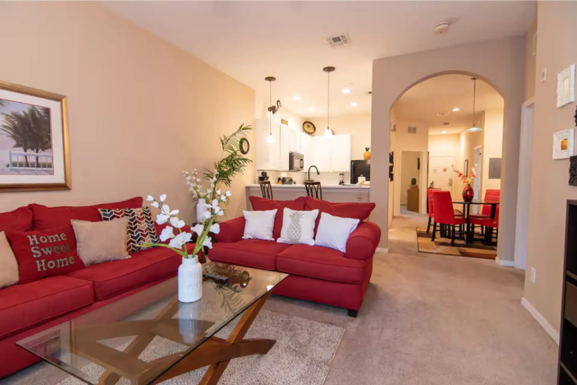 Bright and inviting living room with comfortable seating and an open layout to the kitchen and dining area.