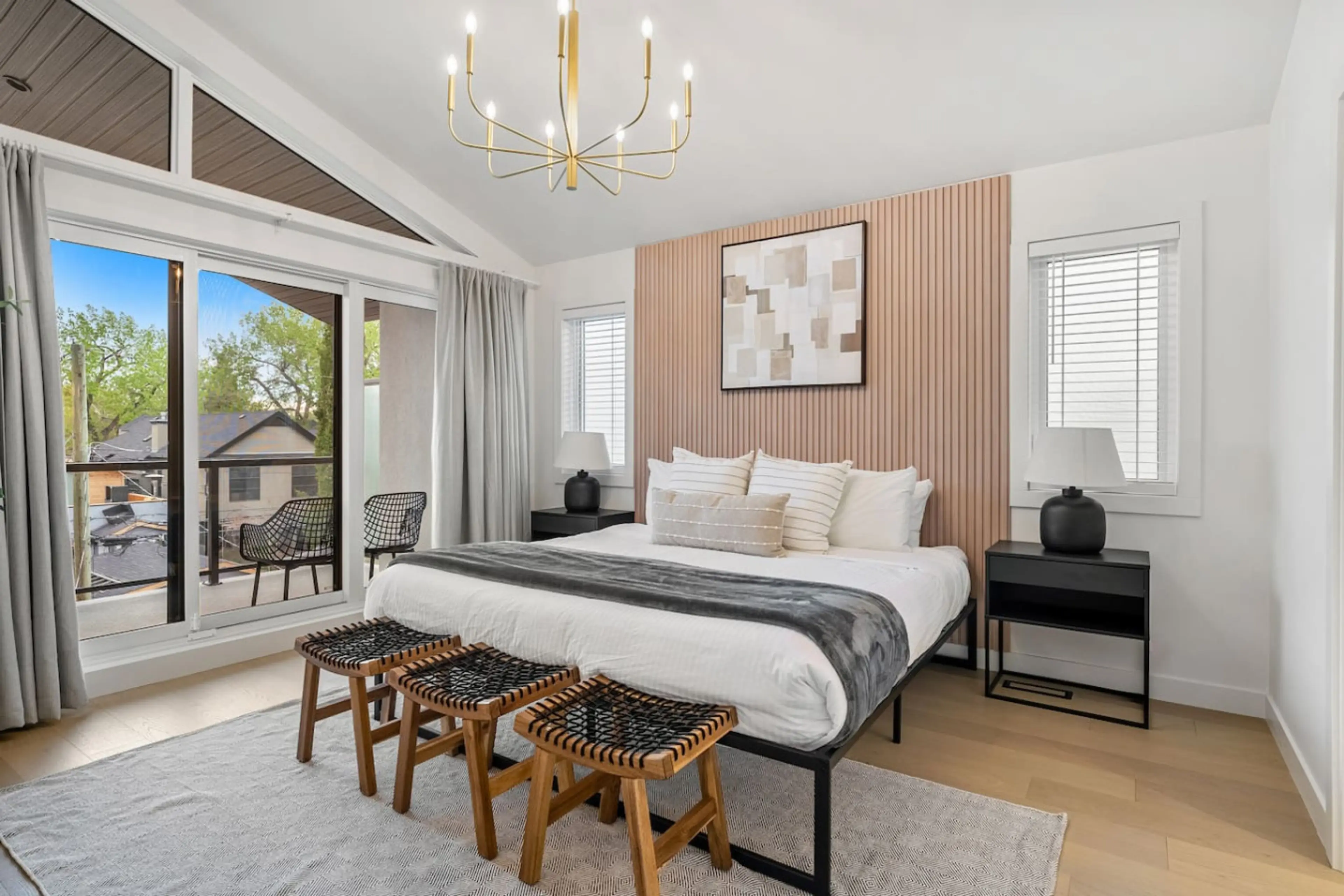 Primary bedroom, located on the top (3rd) floor, with a king bed, private balcony & full ensuite bathroom.