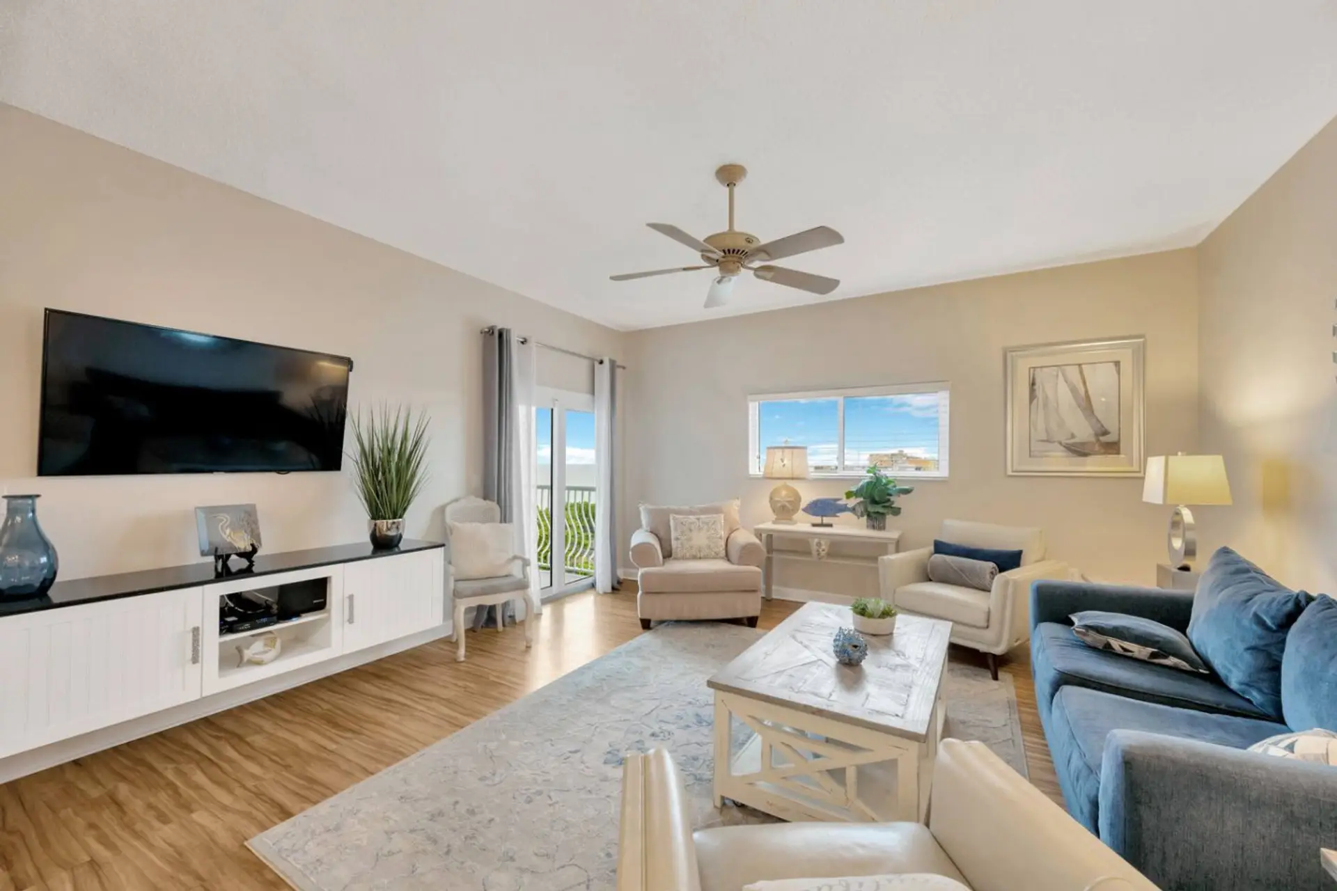 Spacious open Living room with sliding glass doors to the balcony.