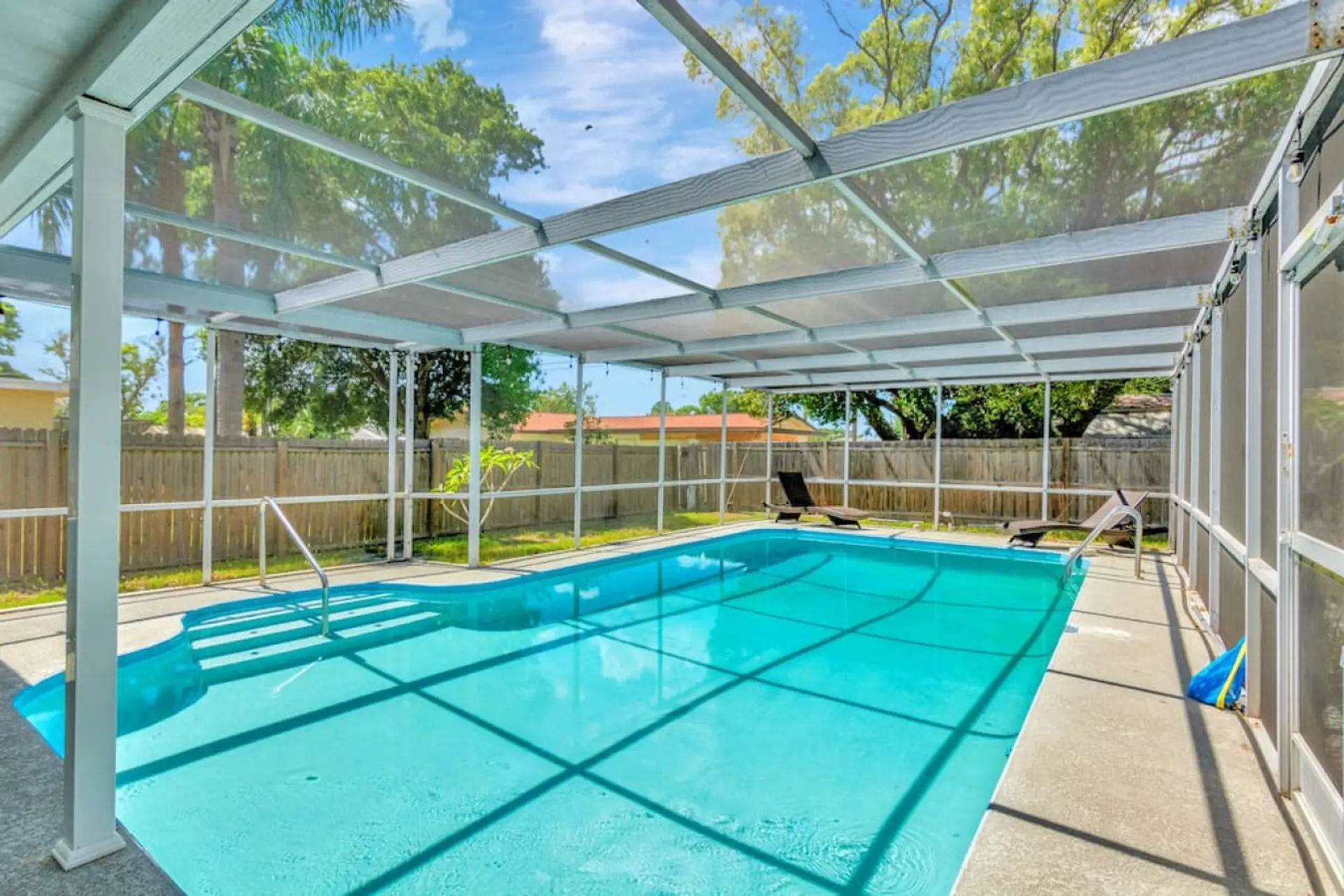 Large screened swimming pool with a shHeated saltwater swimming pool with a shallow end and deep end.  allow end and deep end.