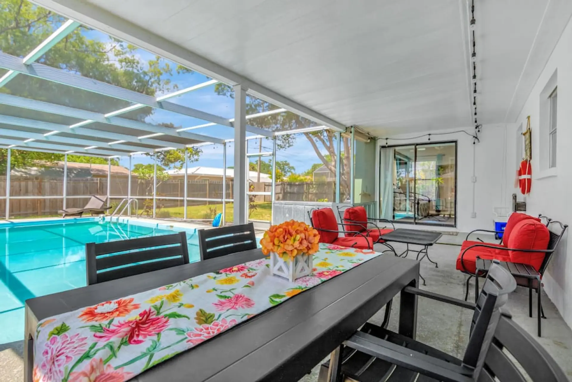 Covered poolside dining and seating area.