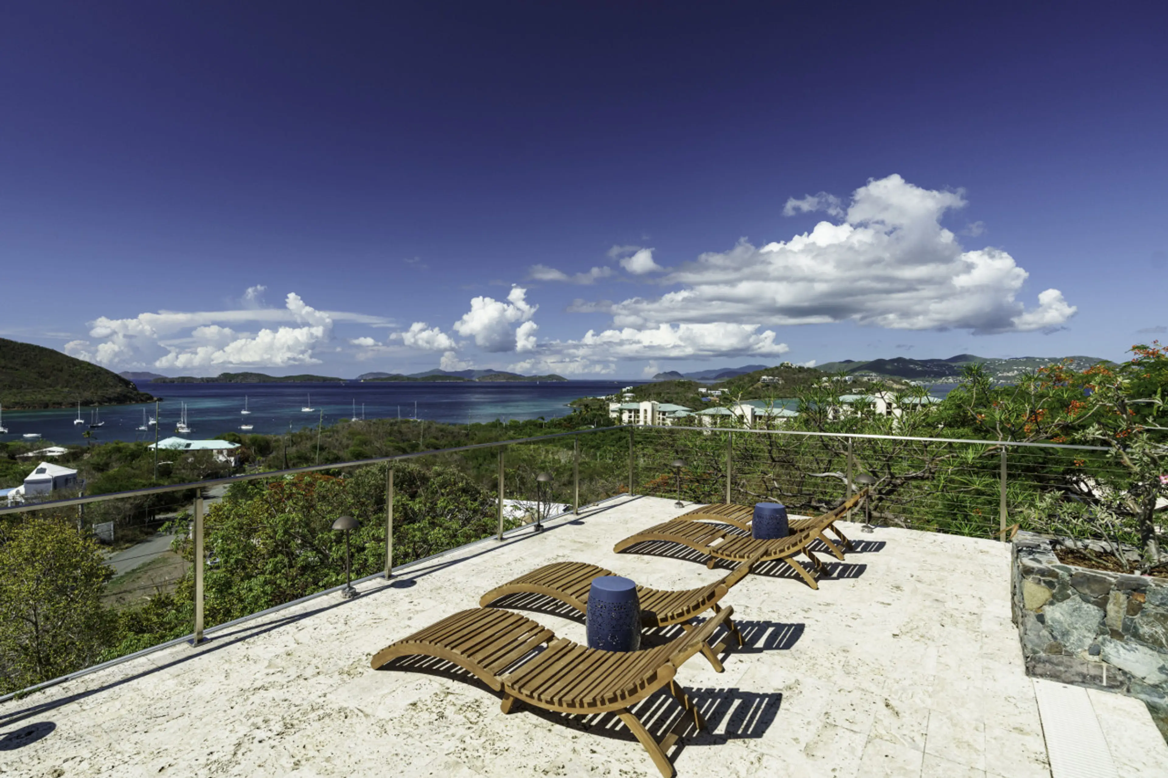The spacious pool deck with incredible views, wifi, sun loungers, and 2 covered sitting areas.