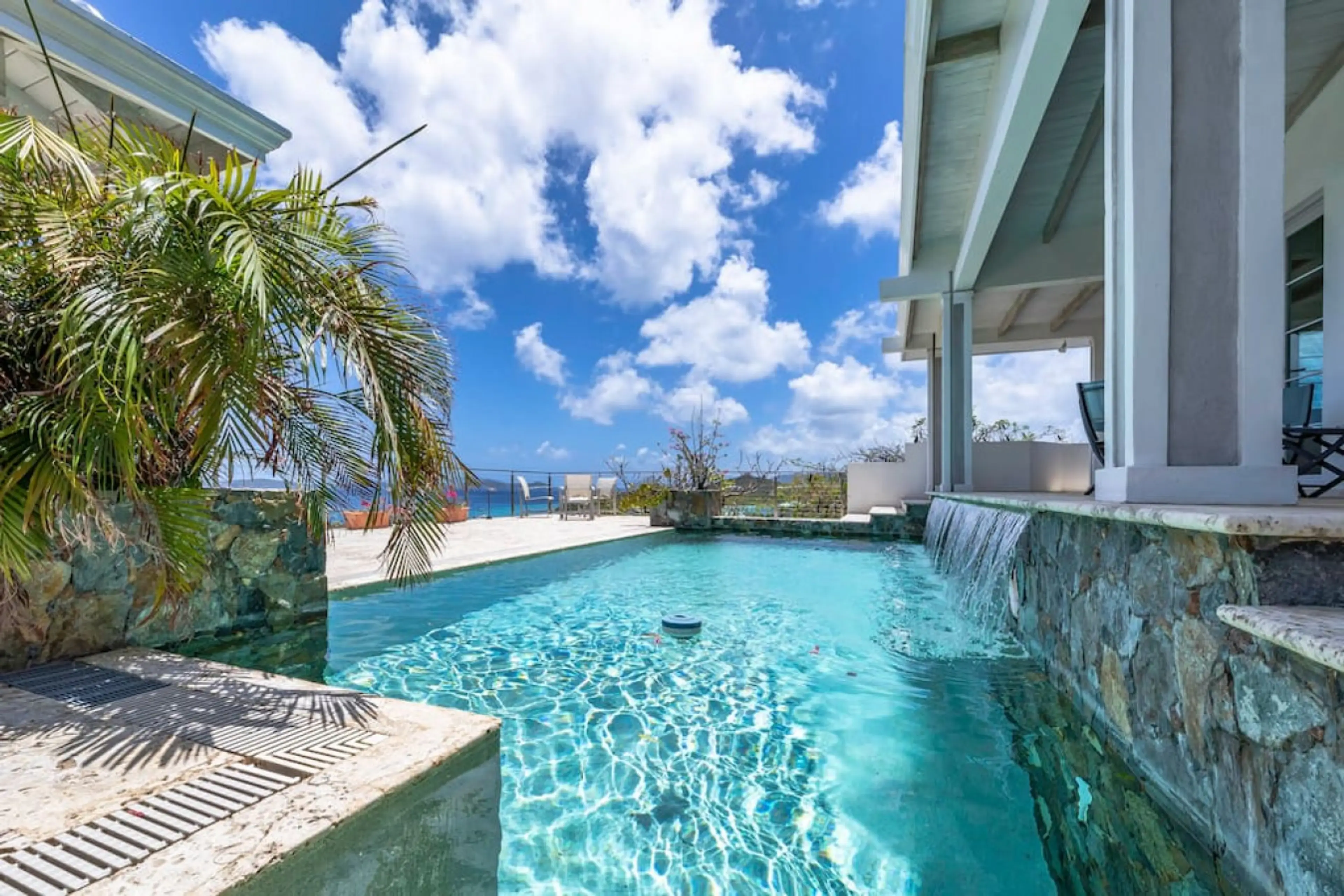 The spacious pool deck with incredible views, wifi, sun loungers, and 2 covered sitting areas.