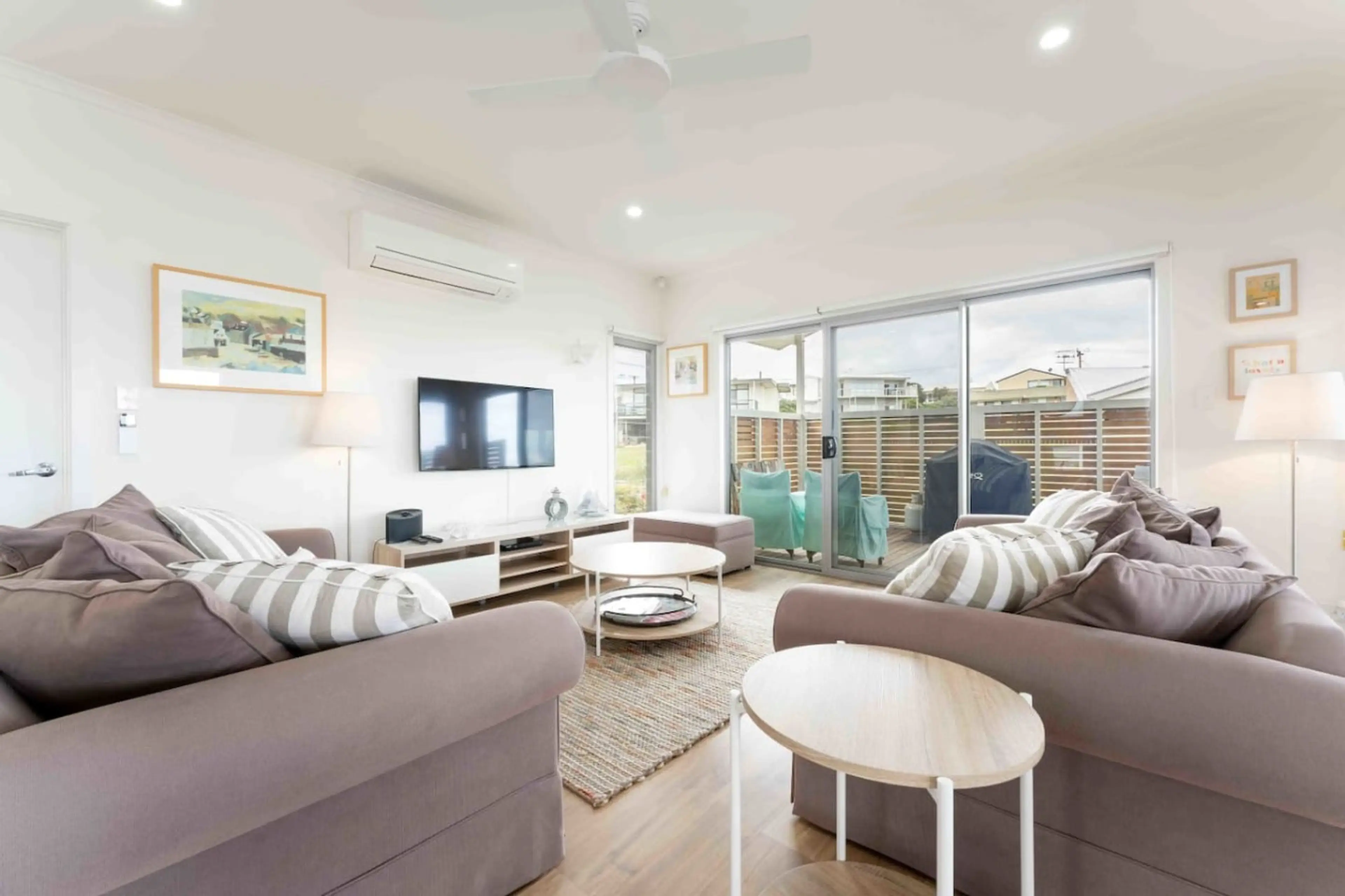 Comfy sofas, sliding doors to the patio, and a big screen ready for movie marathons.