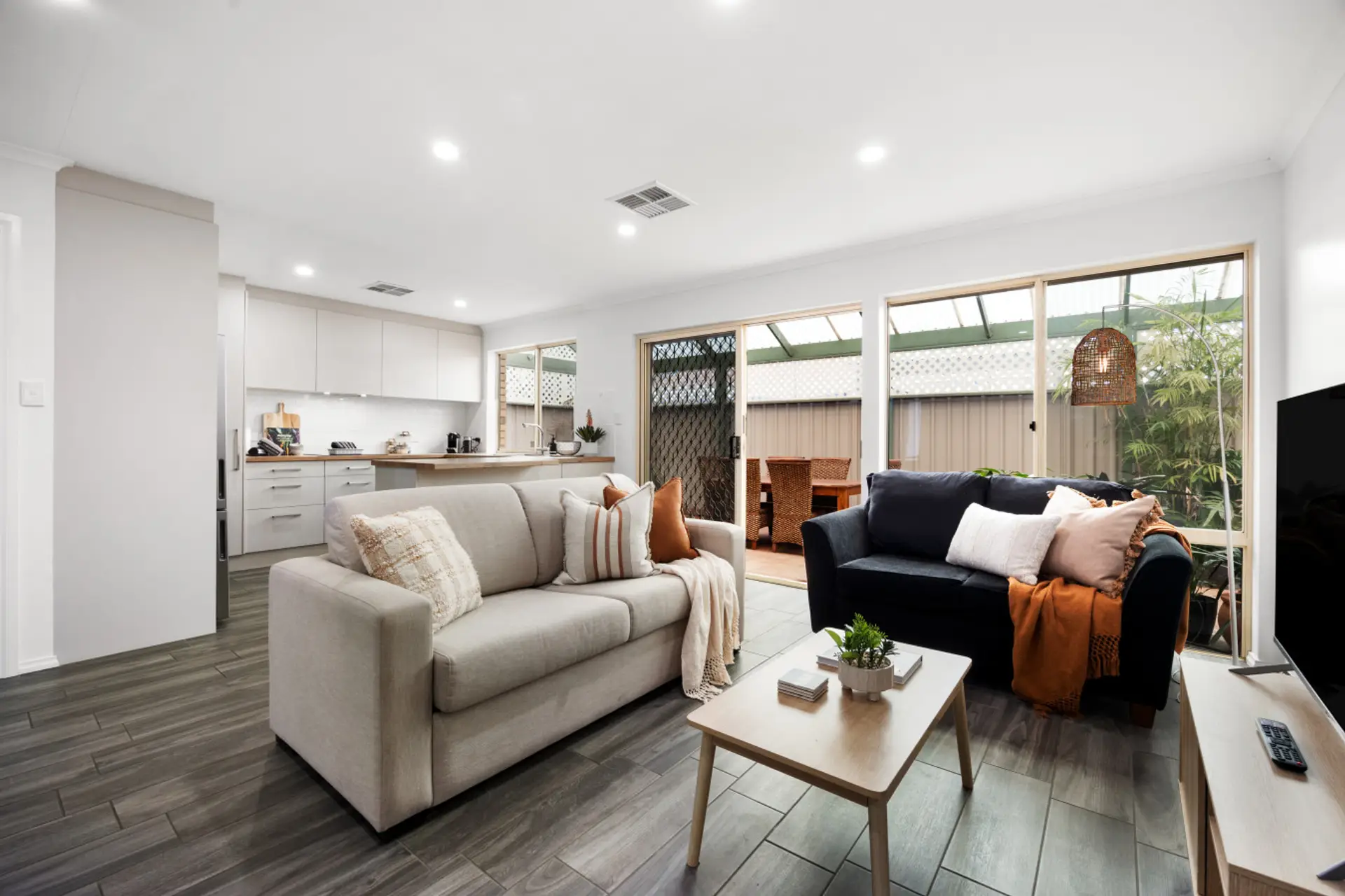 The open-plan design connects living, dining, and kitchen areas seamlessly, creating a spacious flow ideal for gathering, working remotely, or simply unwinding together.