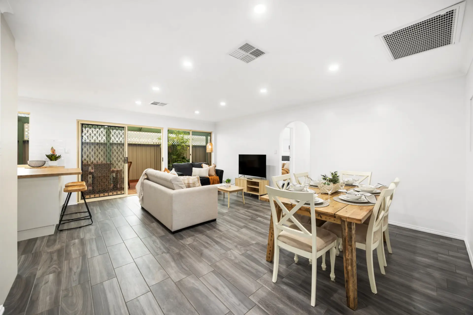 Share meals or plan your day around the rustic timber table for six, set beneath gentle lighting that brings warmth and connection to every conversation.