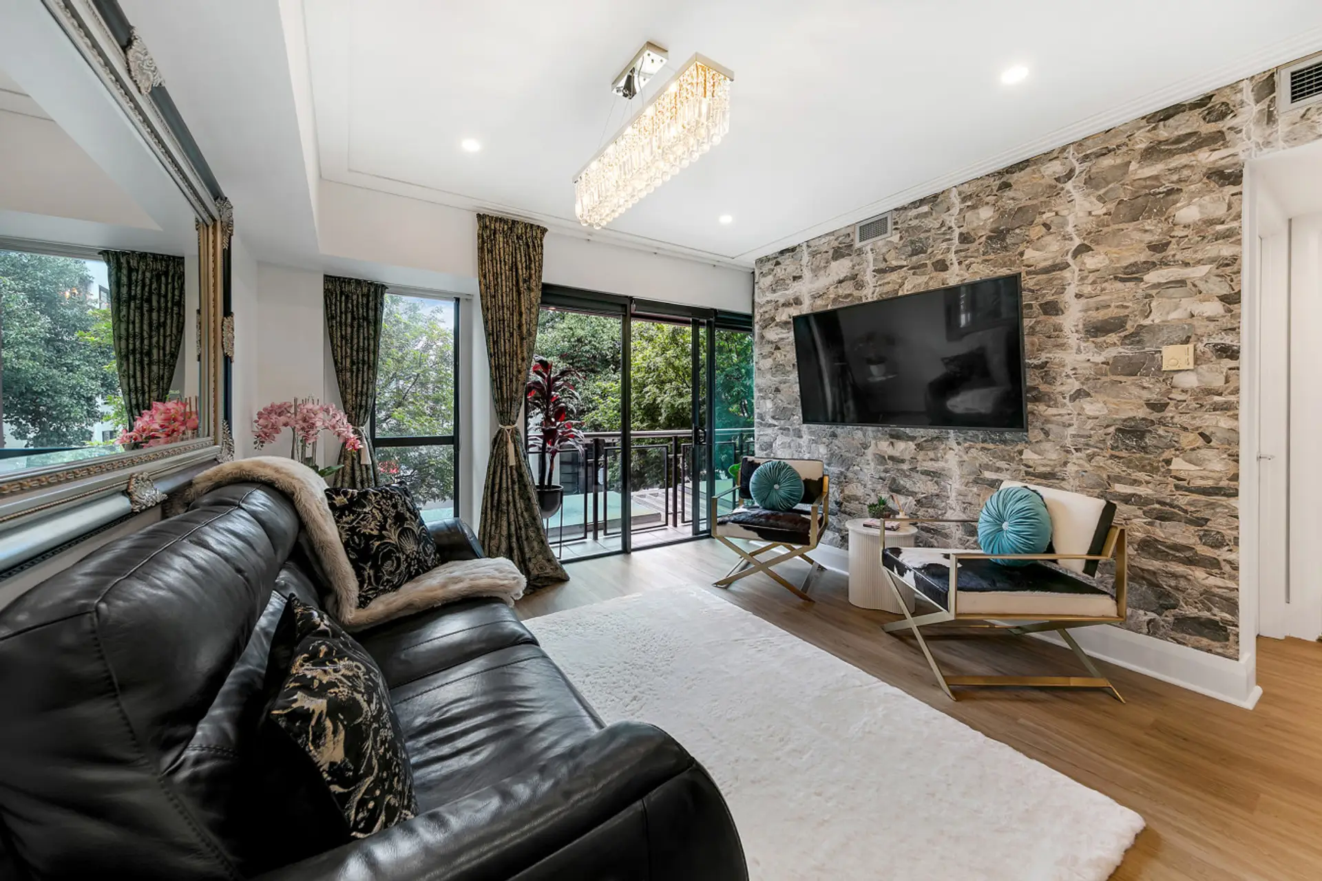 Step into the sophisticated living space of The Celebrity, where a stunning natural stone feature wall sets the tone for your Viaduct escape. Sink into the leather recliner sofa, stream your favourites on the large smart TV, and let the natural light pour