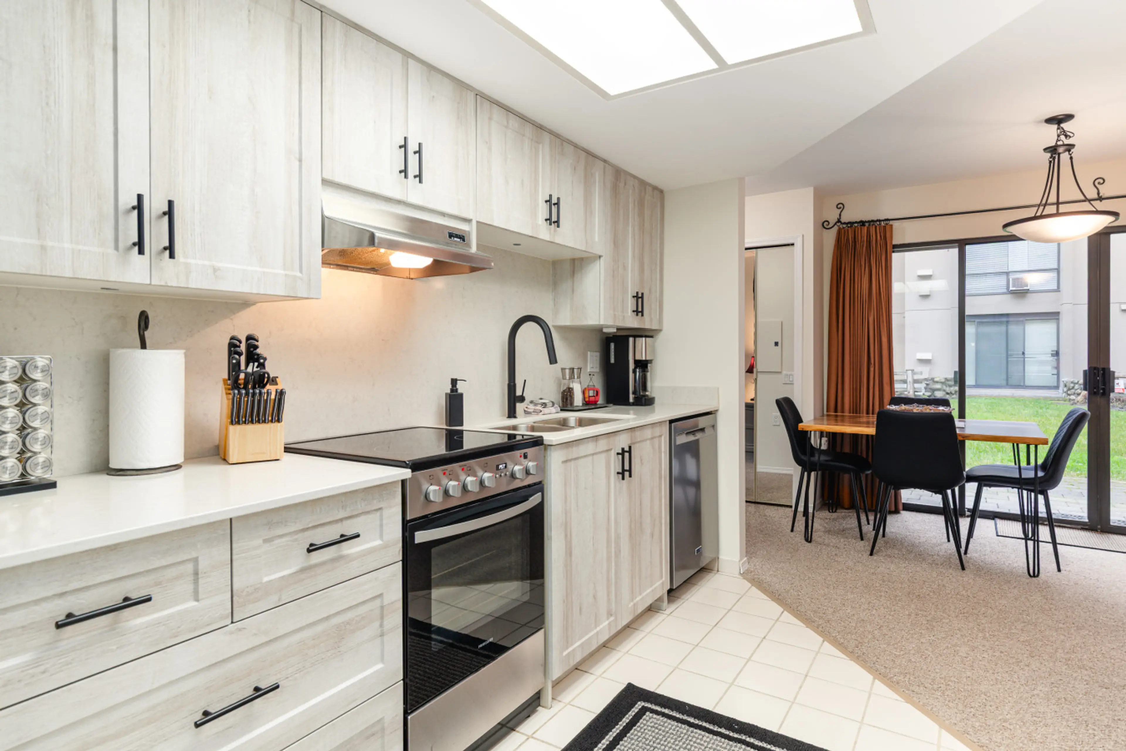 Once you first walk in to the suite you will enter through the kitchen area.   The kitchen has all of the essentials like an oven, fridge, dishwasher, and coffee maker.