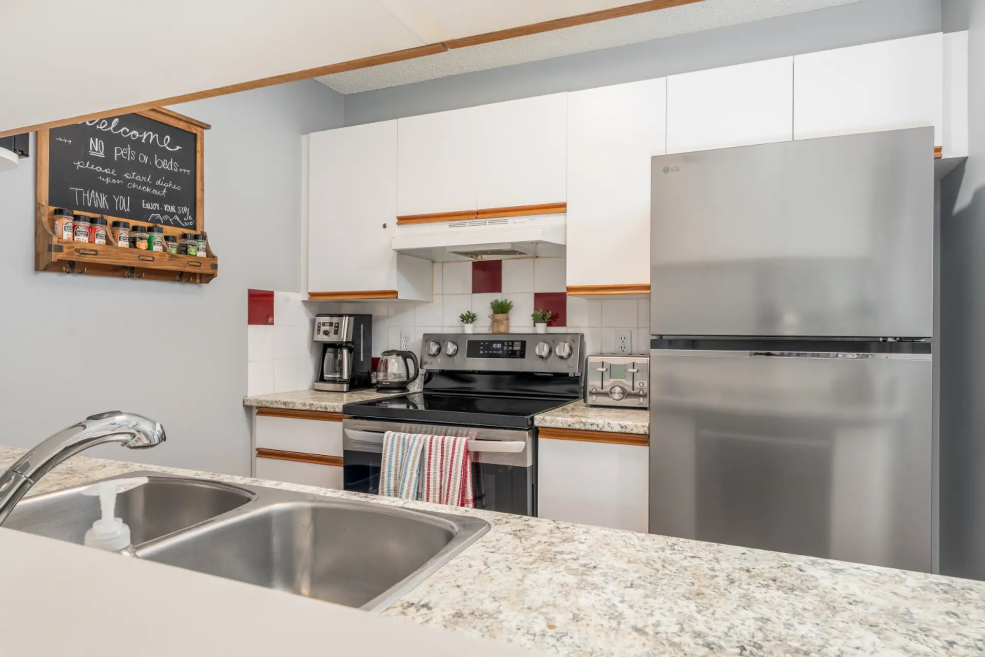 Bright and fully stocked kitchen with pots and pans, and cutlery.