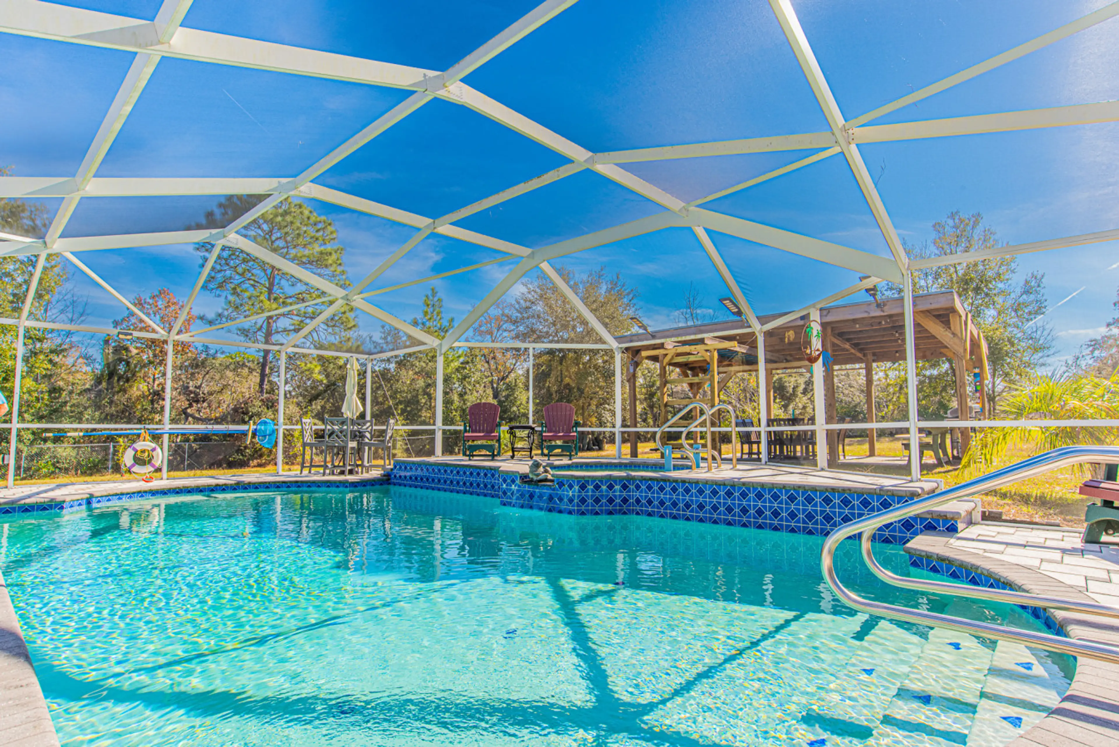 Pool and hot tub combo along with seating for all.