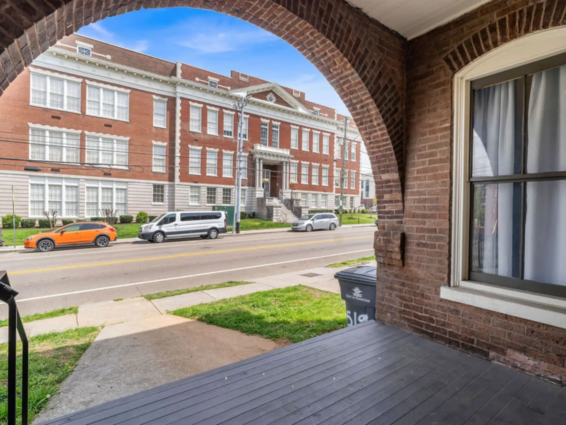 Porch View: Enjoy vibrant street scenes and neighborhood charm from your private retreat!