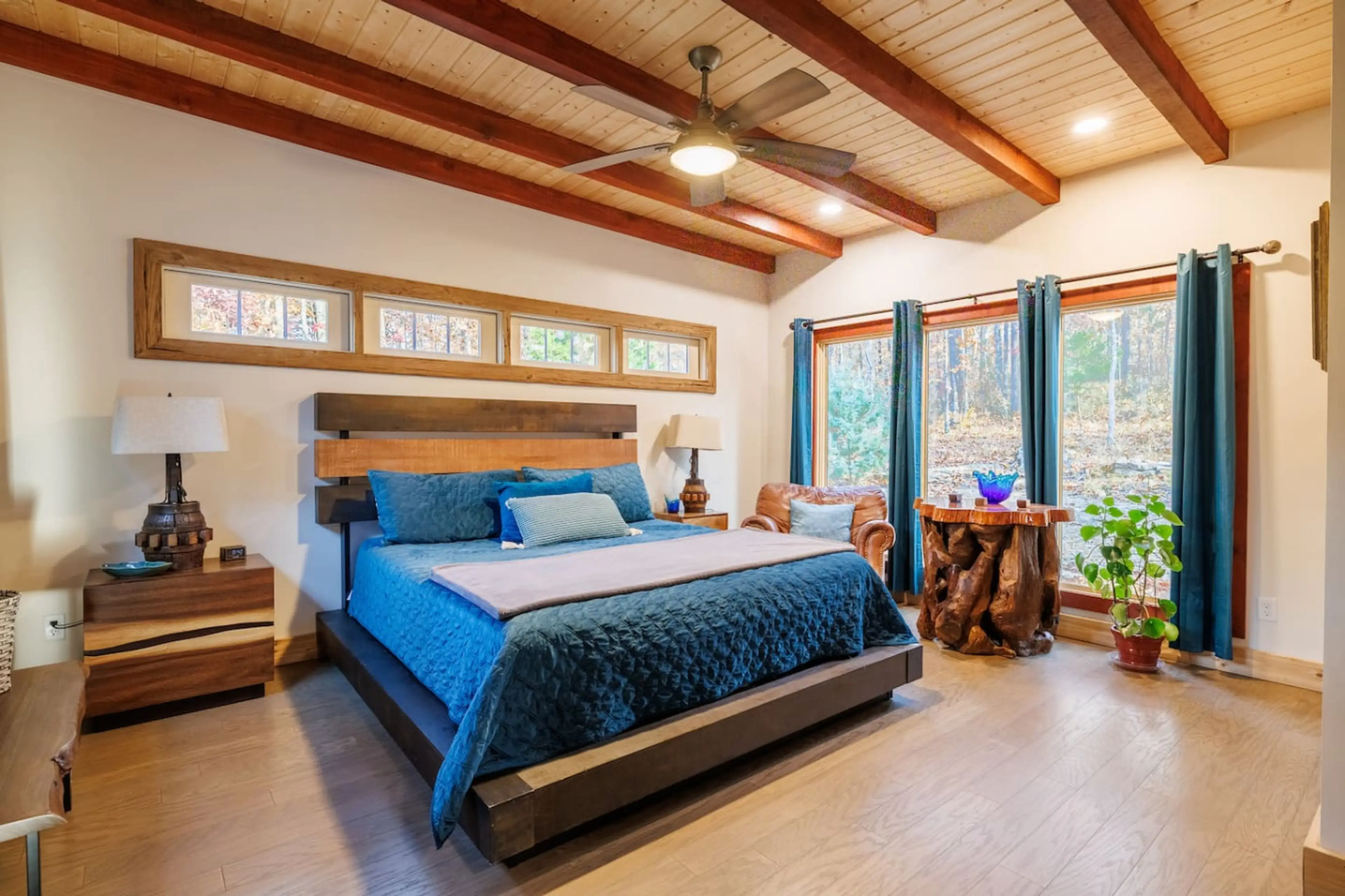This king-size bed with beams on the ceiling and huge windows offers your personal vacation from adulting.