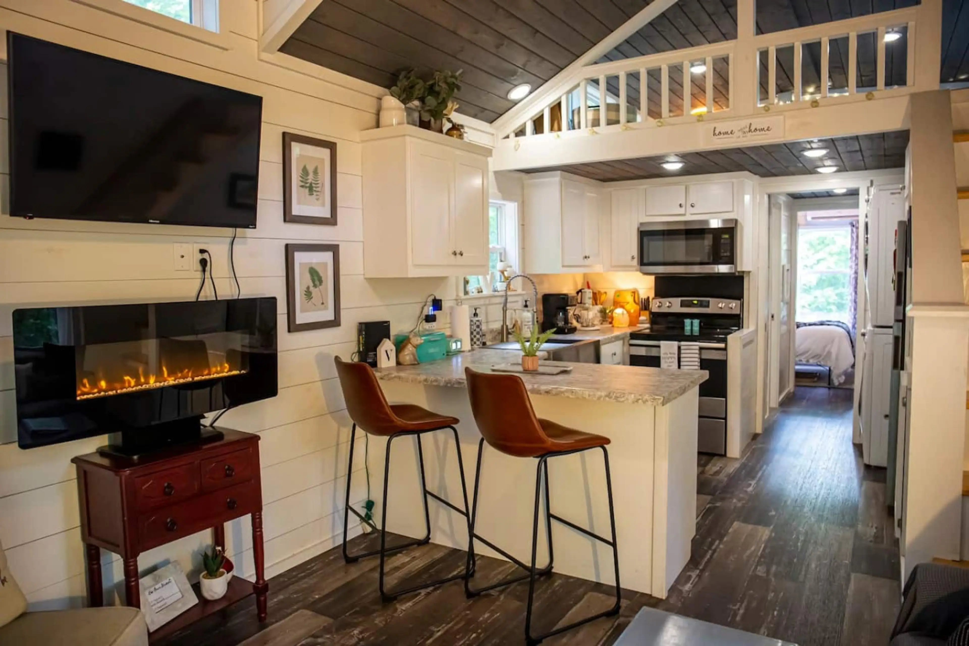 Cozy farmhouse-style tiny house with an electric fireplace and Wi-Fi—perfect for streaming or working from home with a change of scenery. Enjoy a fully equipped kitchen, a main-floor master bedroom, and comfy bunk beds.