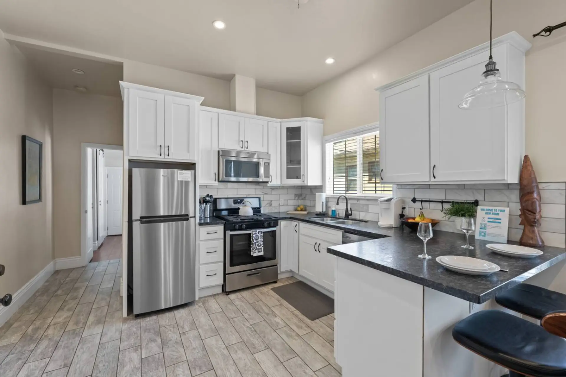 A full-sized kitchen equipped with all the essentials to prepare a delicious home-cooked meal, including pots, pans, olive oil, salt, pepper, and more.