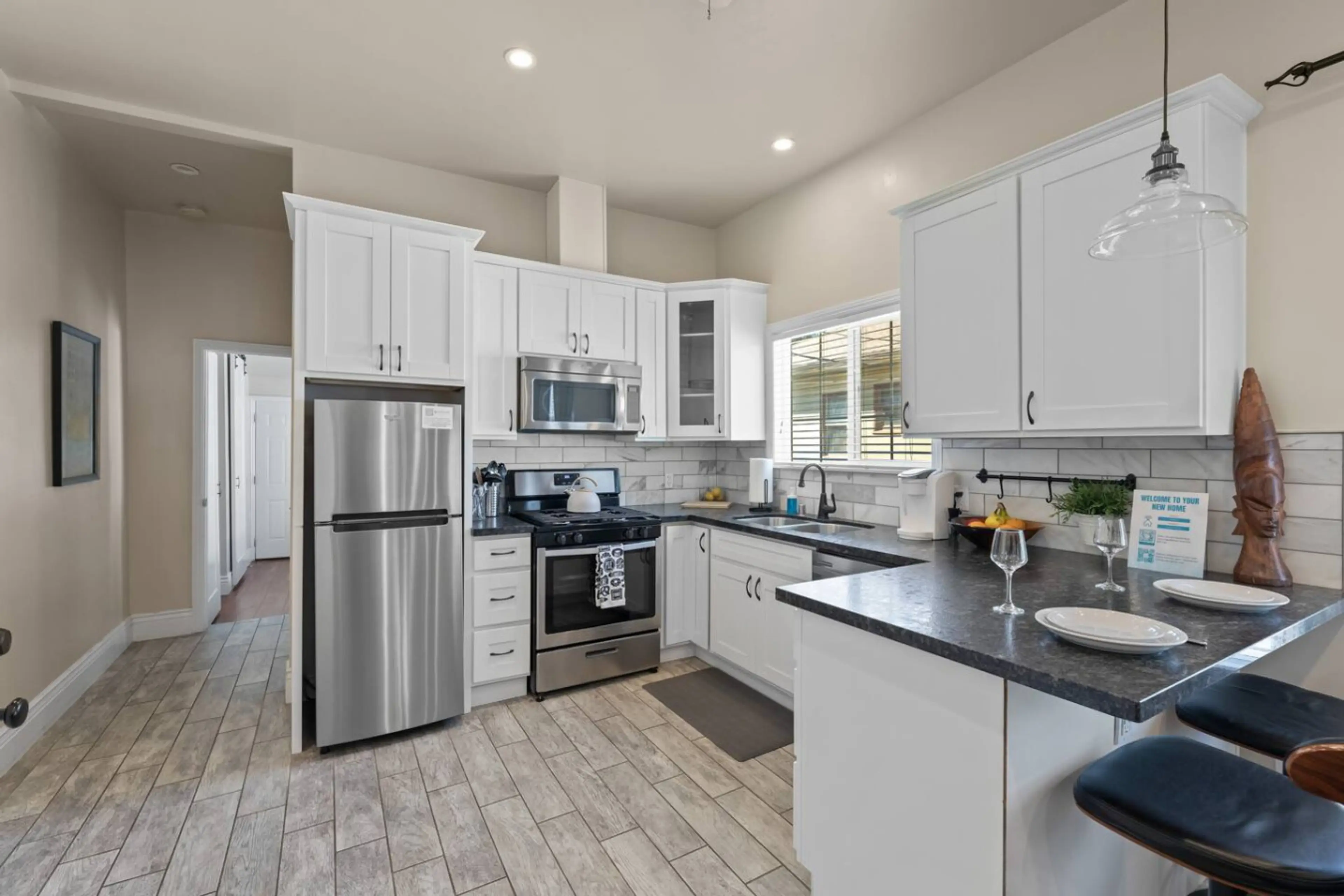 A full-sized kitchen equipped with all the essentials to prepare a delicious home-cooked meal, including pots, pans, olive oil, salt, pepper, and more.