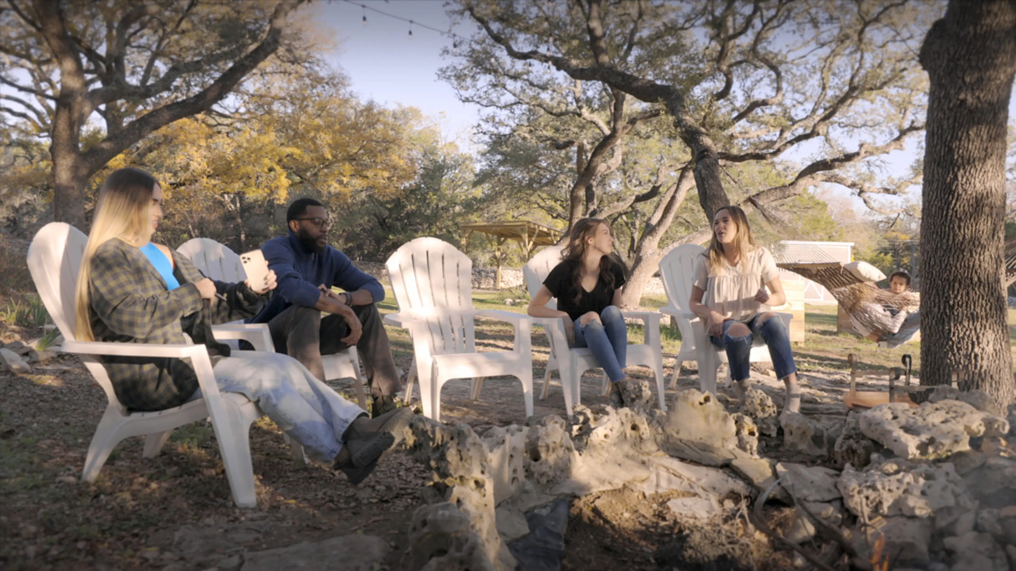 The Lazy Lavender Farmhouse in Wimberley Texas — Friends Gathering Around the Private Fire Pit Under Texas Stars